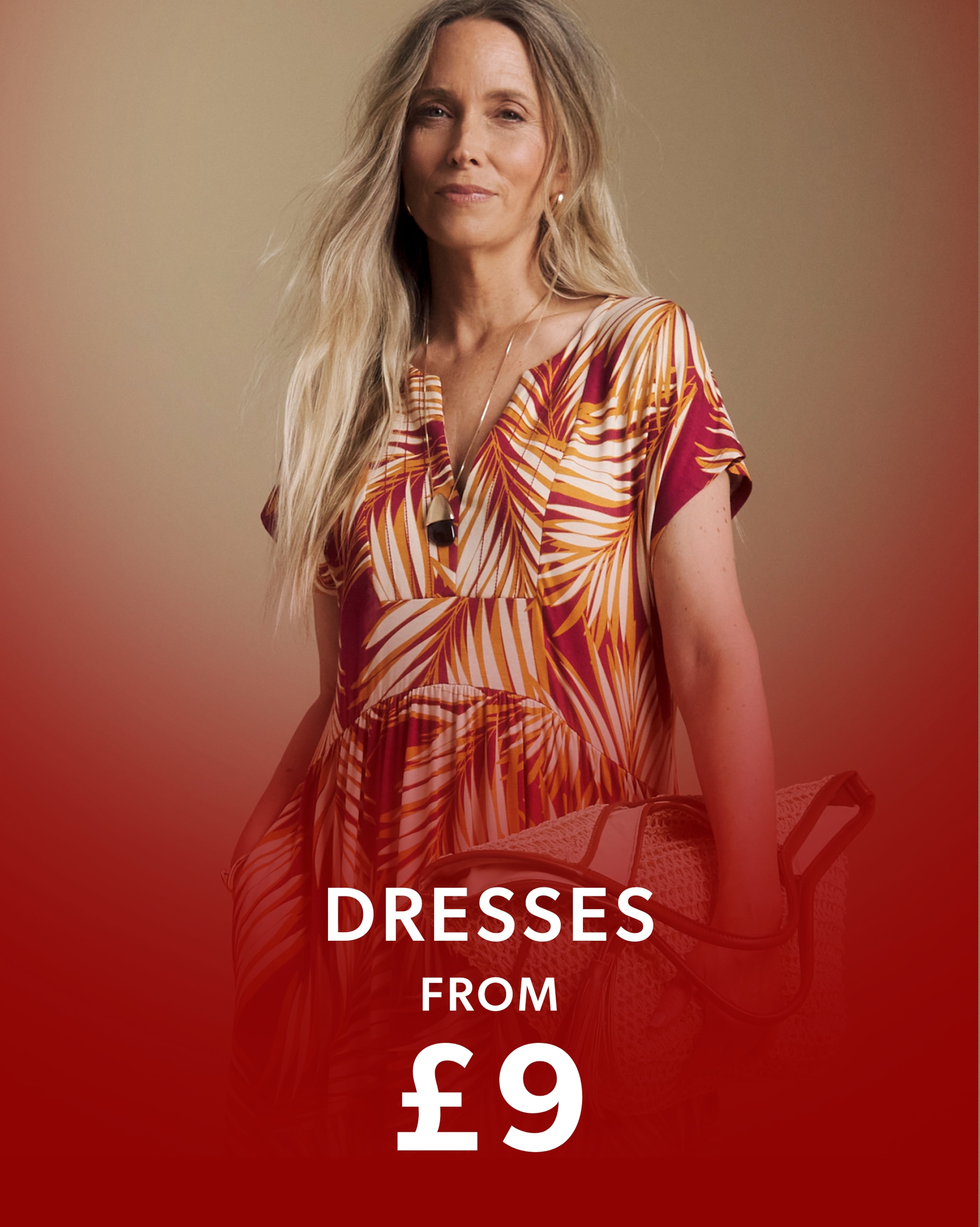 Person wearing a Julipa palm print midi dress and carrying a woven tote bag.