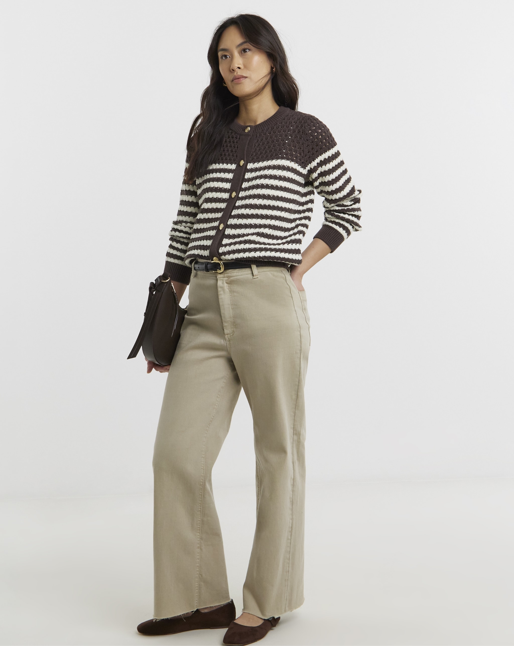 Woman wearing brown stripped cardigan and beige trousers