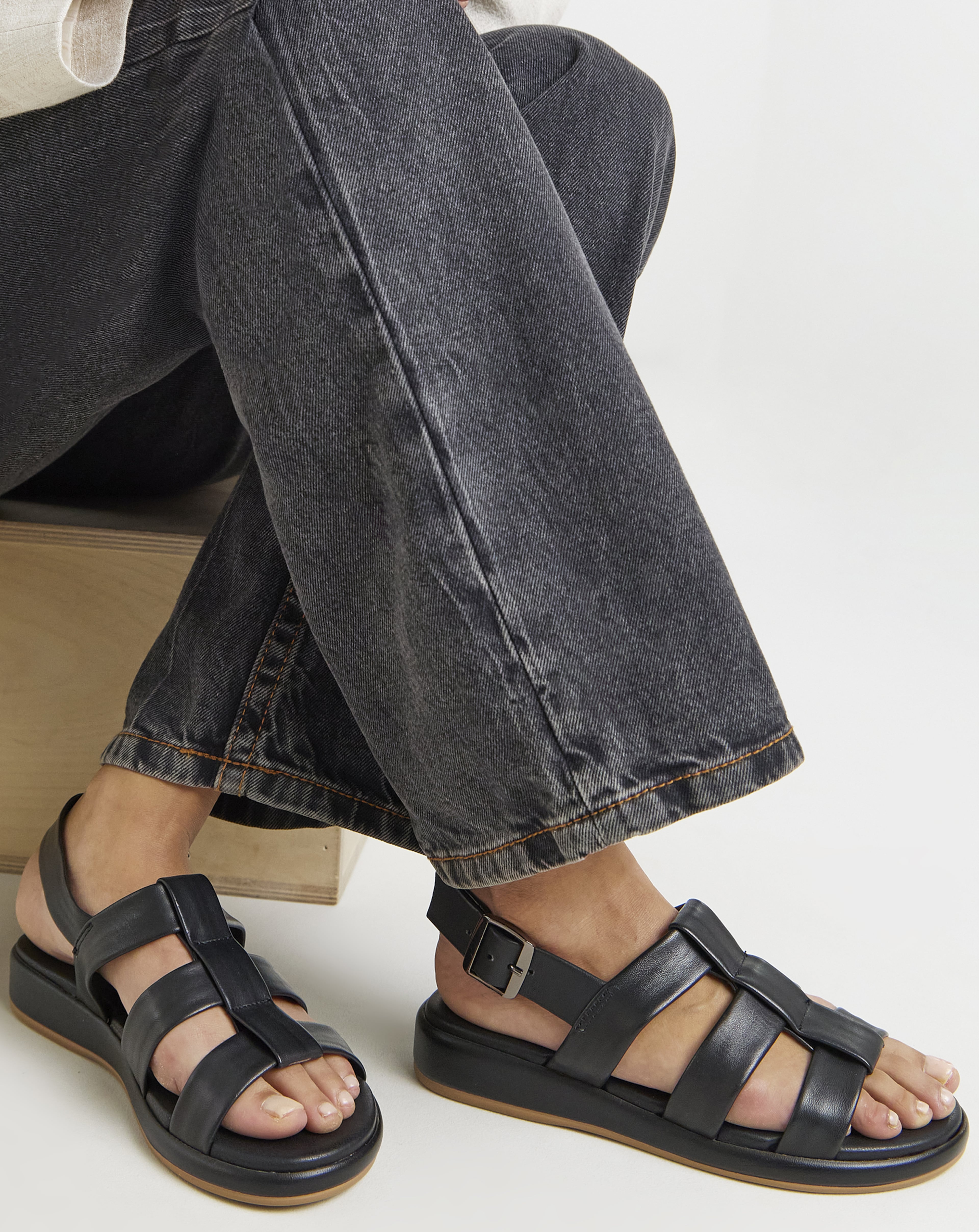 Woman wearing black sandals