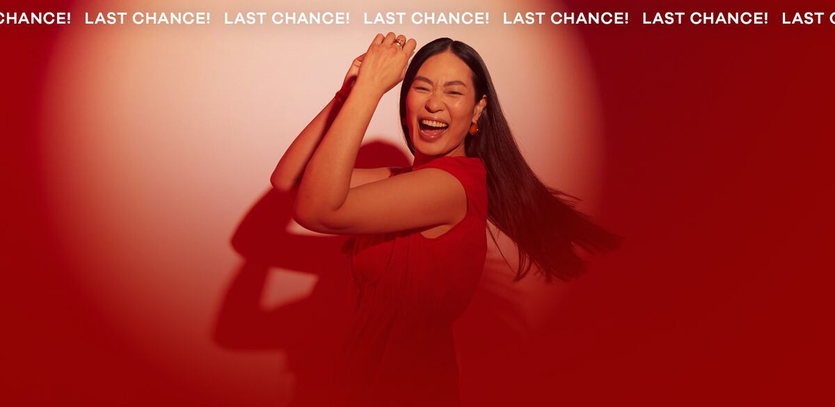 Woman wearing red dress on a red background