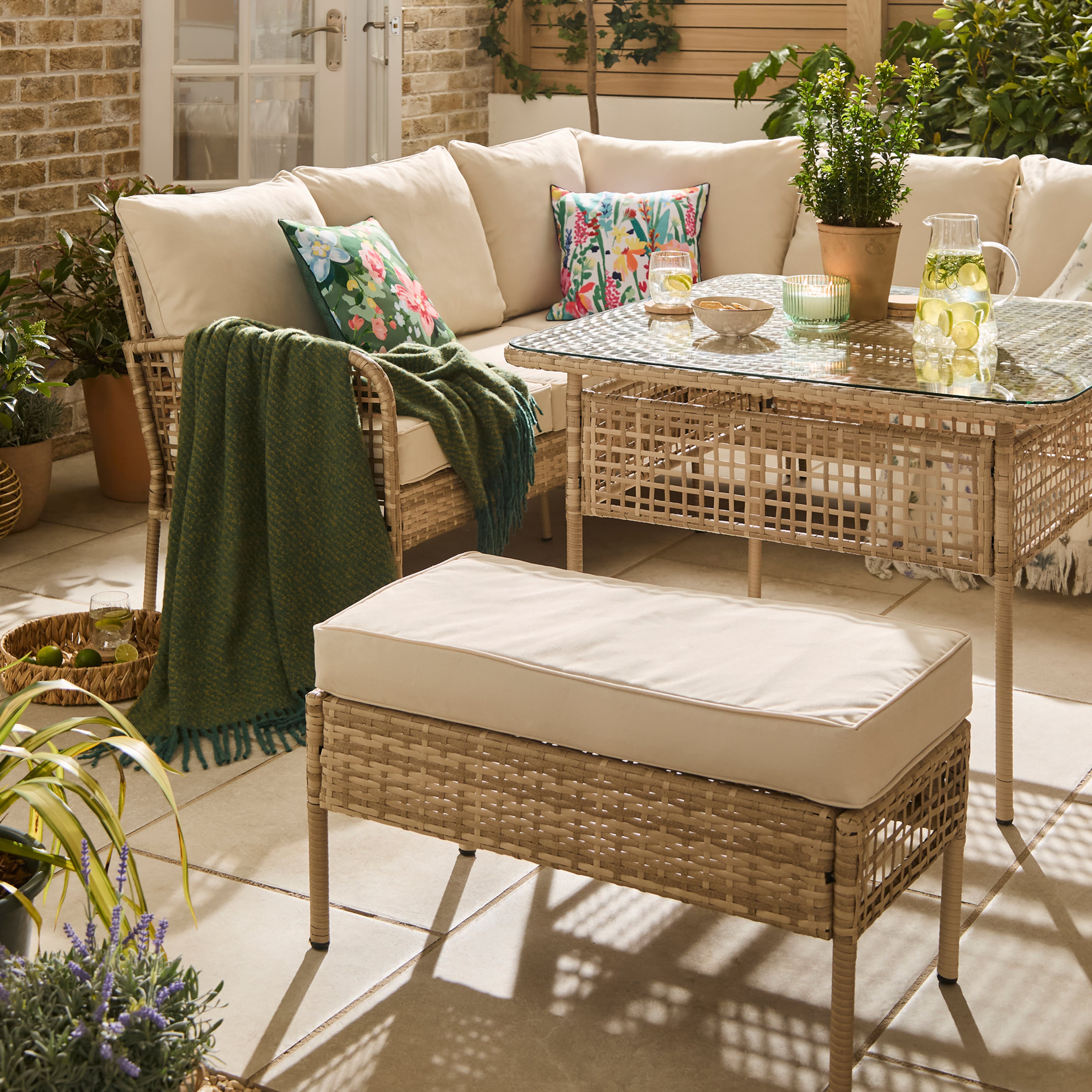 A small garden with and L shaped furniture set.
