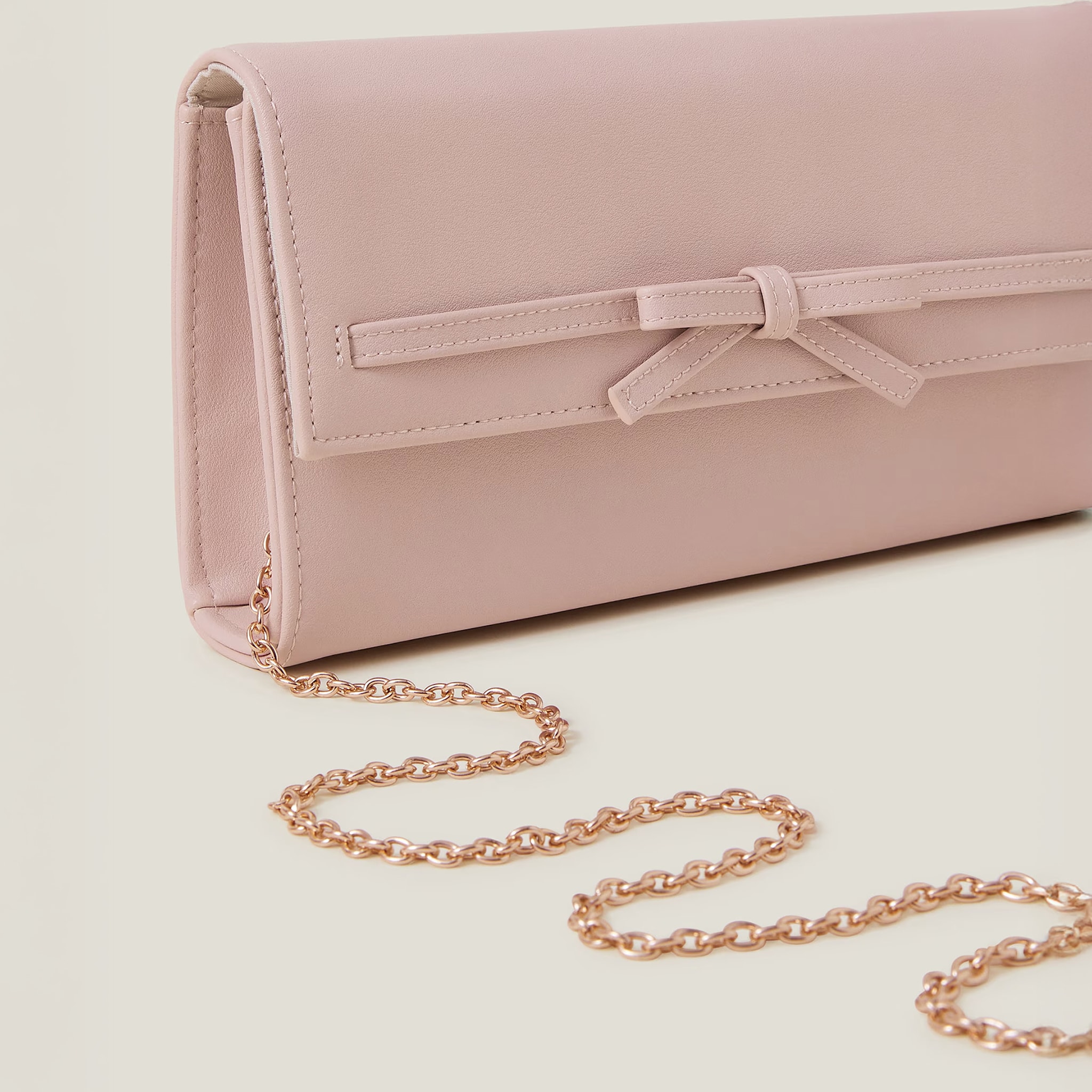 Blush coloured handbag with gold chain strap
