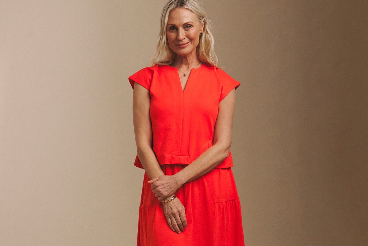 A person wearing a bright red Julipa midi dress