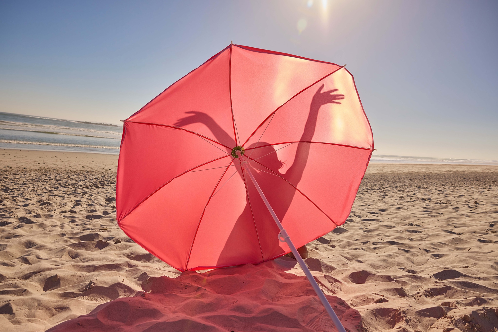 Pink umbrella on a beach
