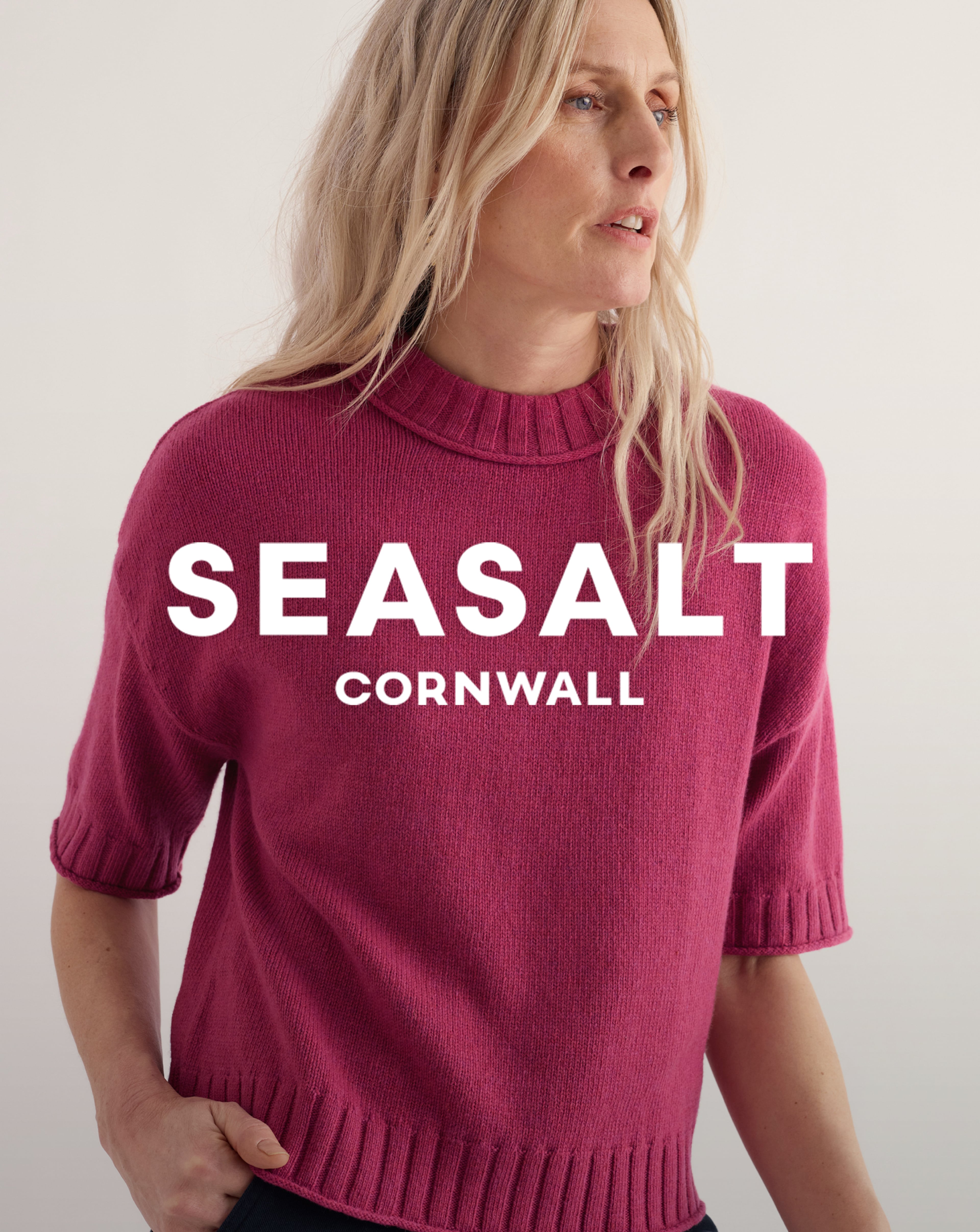 Model is wearing a rose Seasalt Cornwall Fistral jumper.