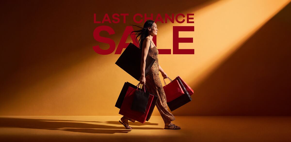 Last Chance Sale banner featuring a shopper carrying multiple bags. 