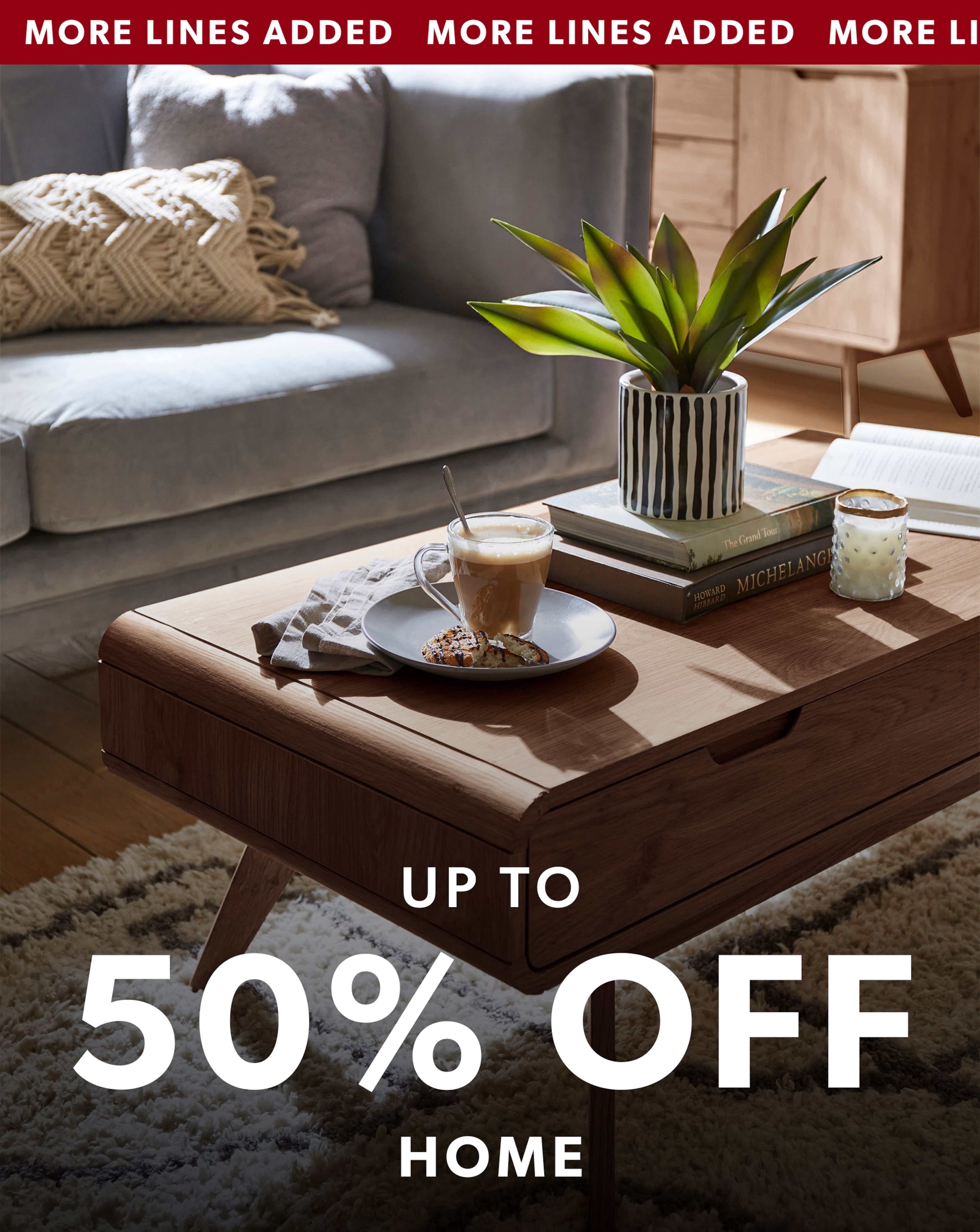 A modern living room featuring a wooden coffee table with the headline “Up to 50% off Home".
