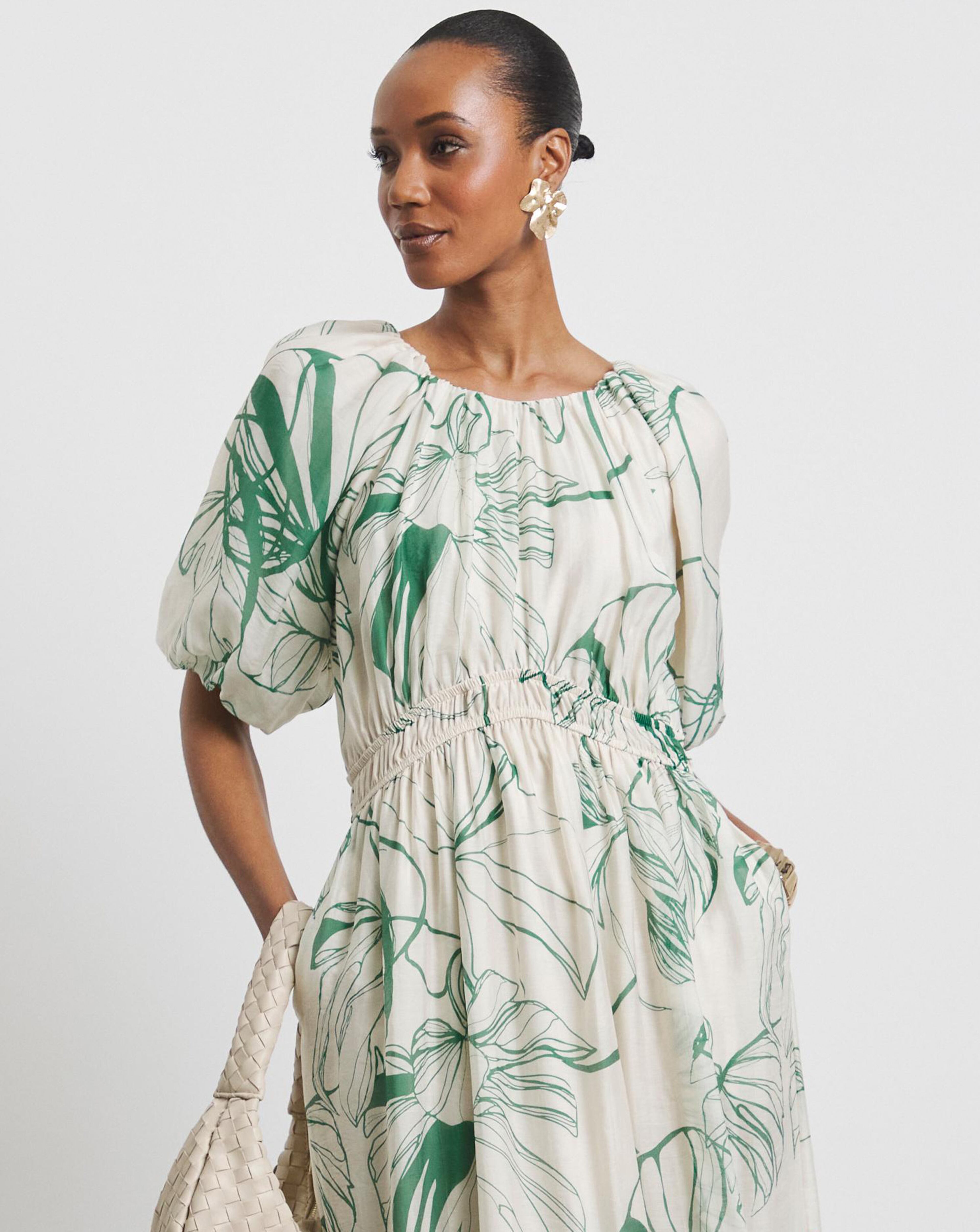 A model wearing a long Joanna Hope print dress. 