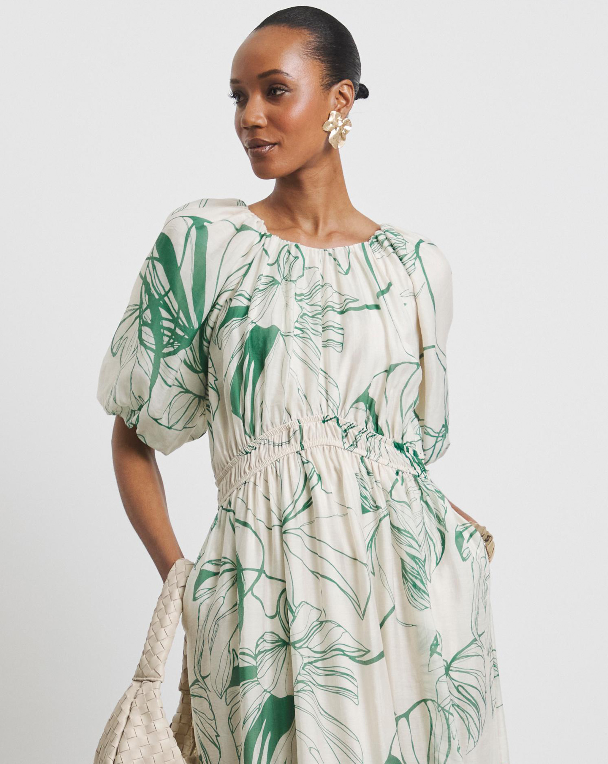 A model wearing a long Joanna Hope print dress.