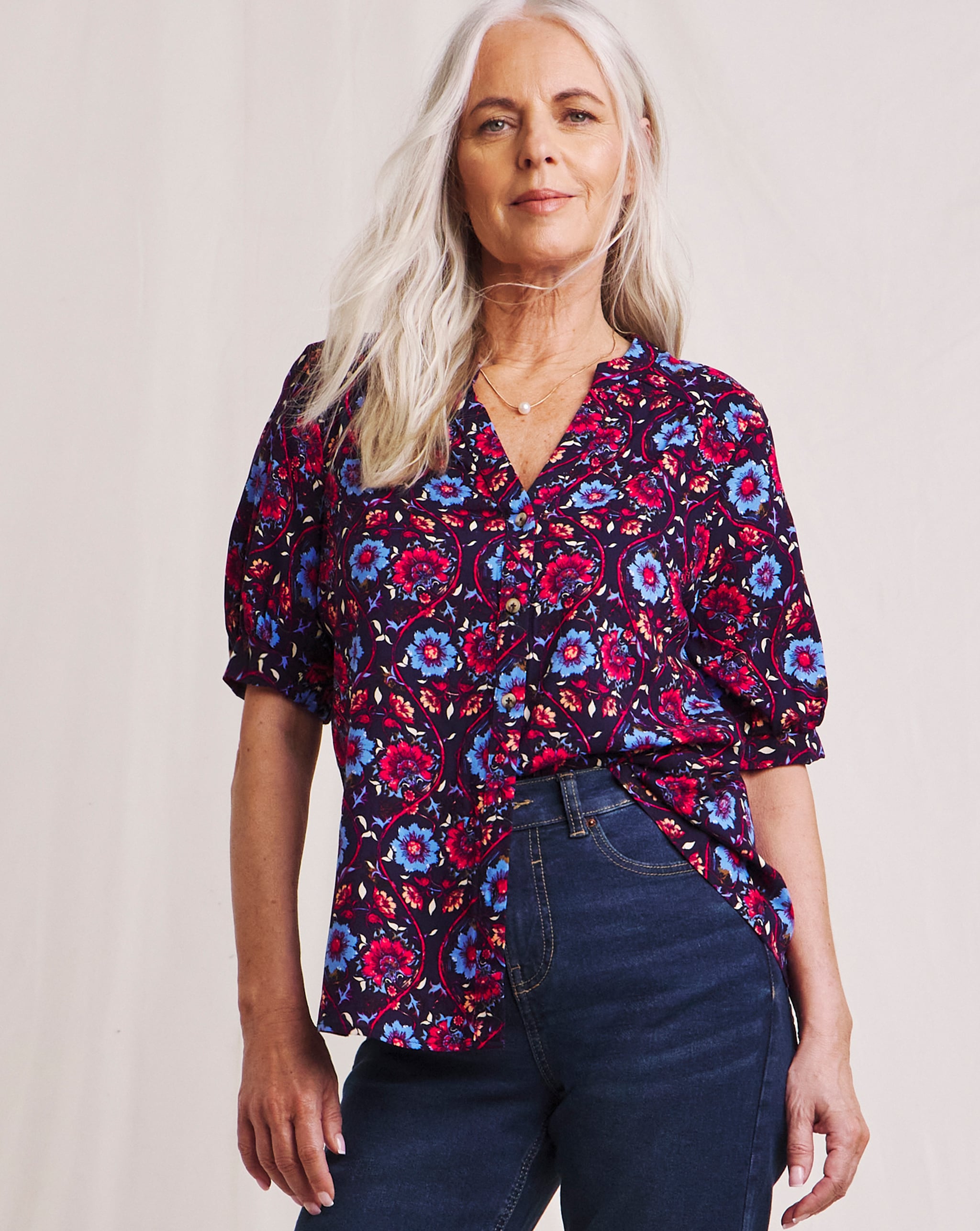 Woman in a pink blue patterned blouse