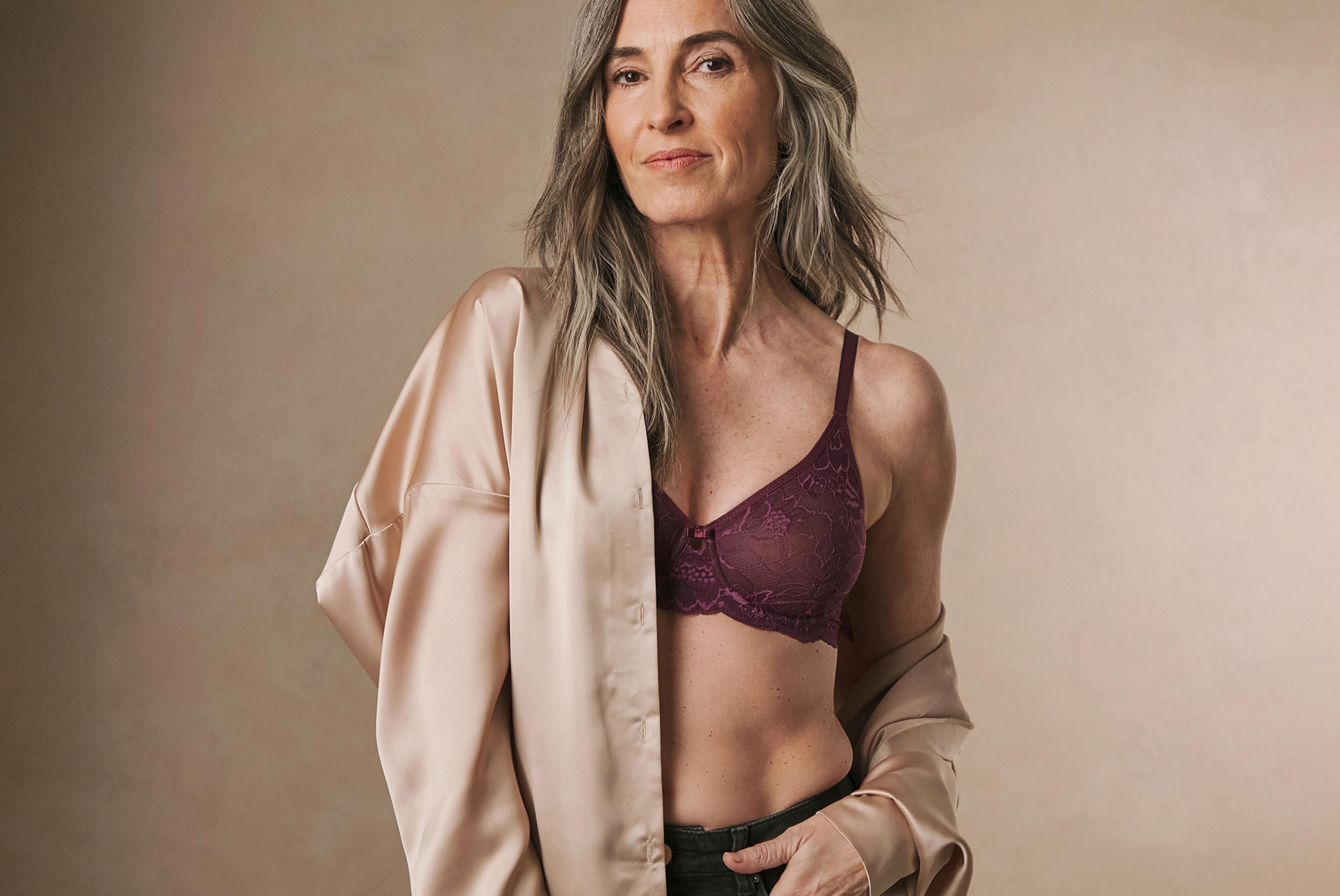 A woman wearing burgundy lingerie