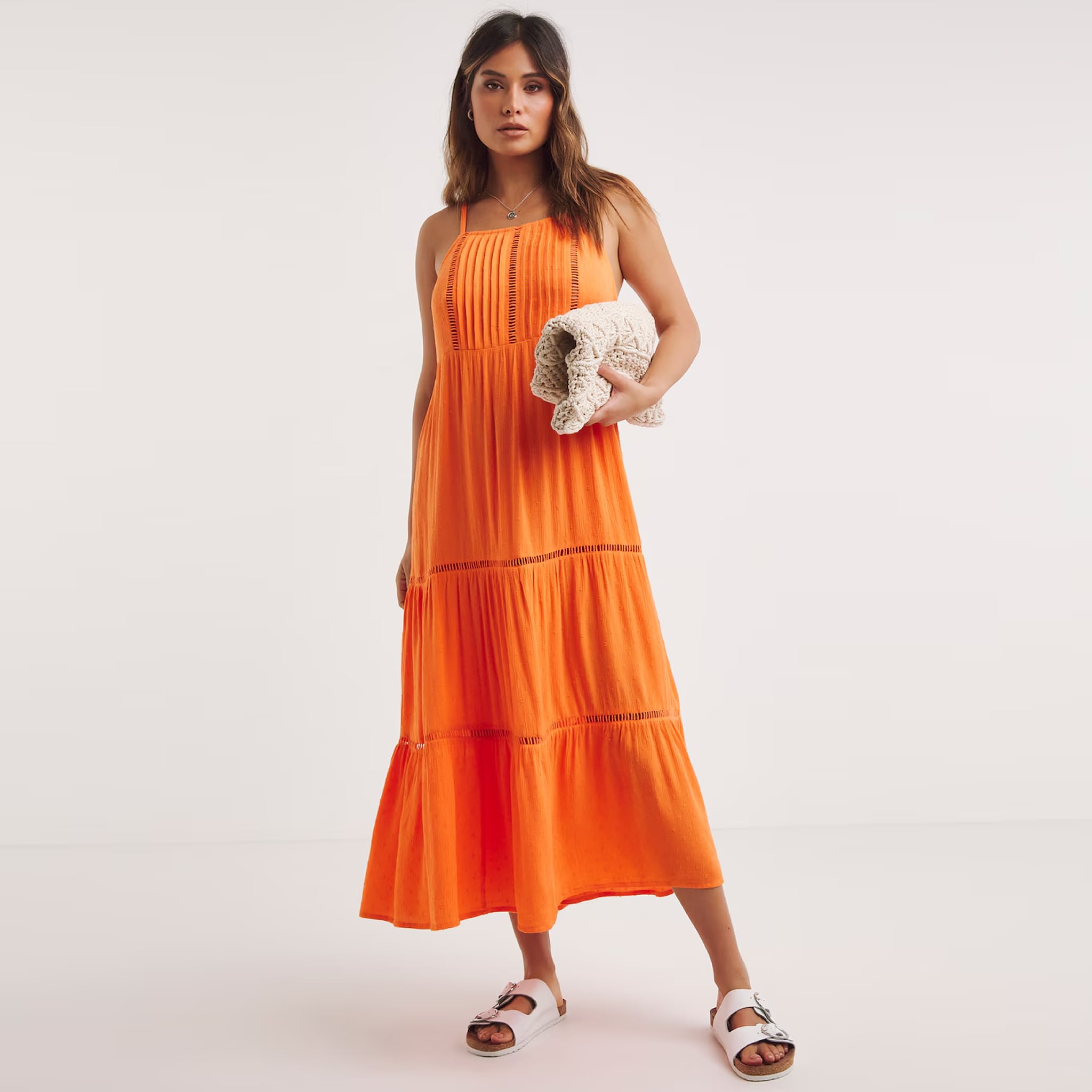 A model wearing an orange beach dress