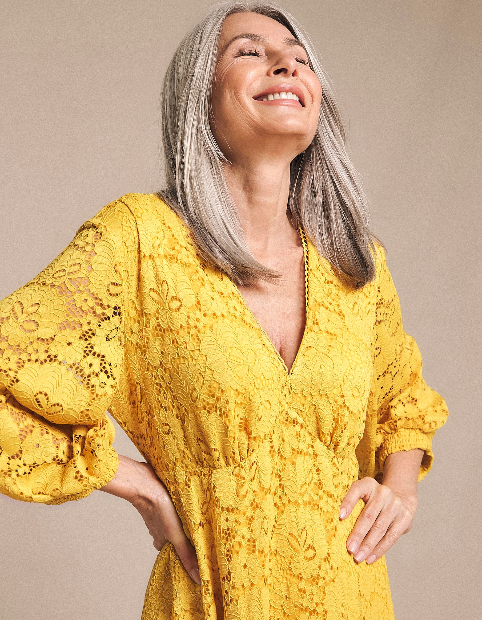 Model wearing a lacy yellow dress