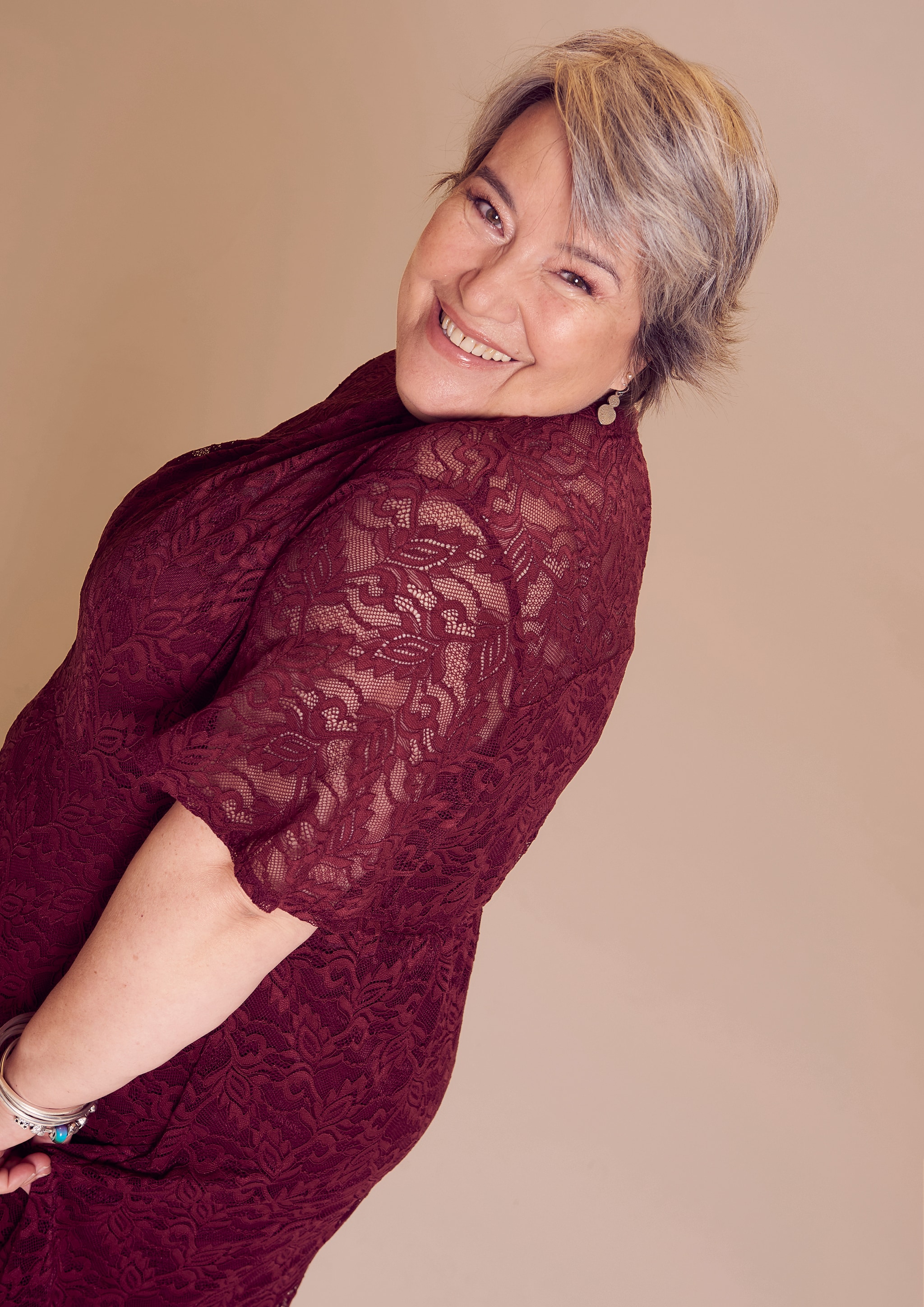 A women wearing a burgundy crochet knit dress