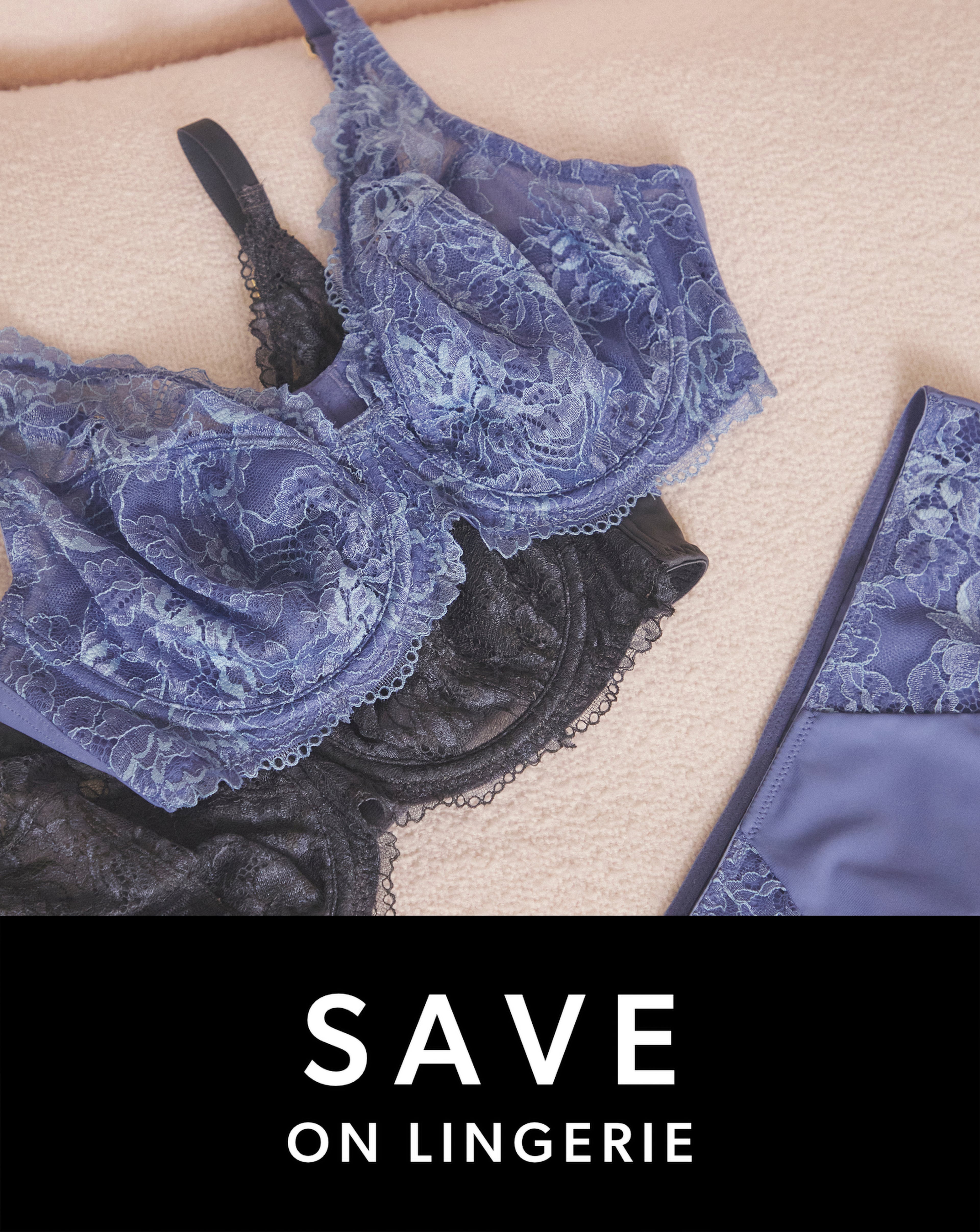 A close-up of lace lingerie in shades of blue and black, including a bra and matching briefs.