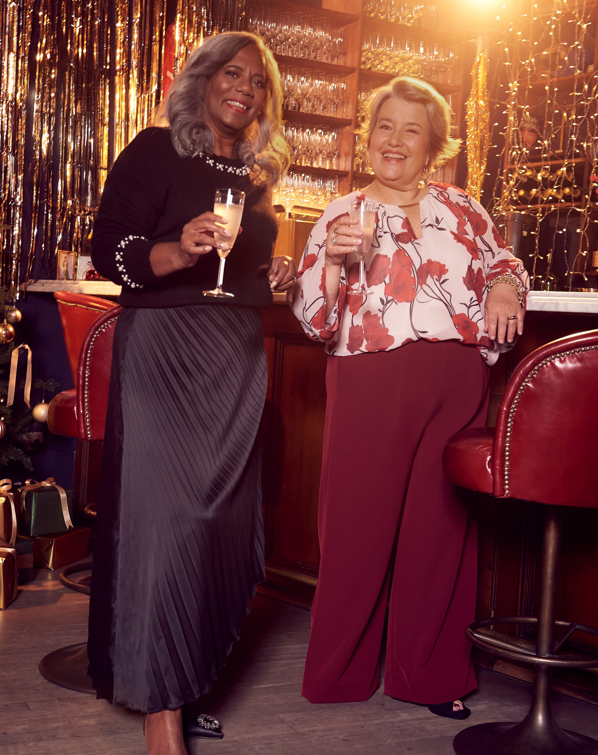 Two women stood in Christmas party outfits