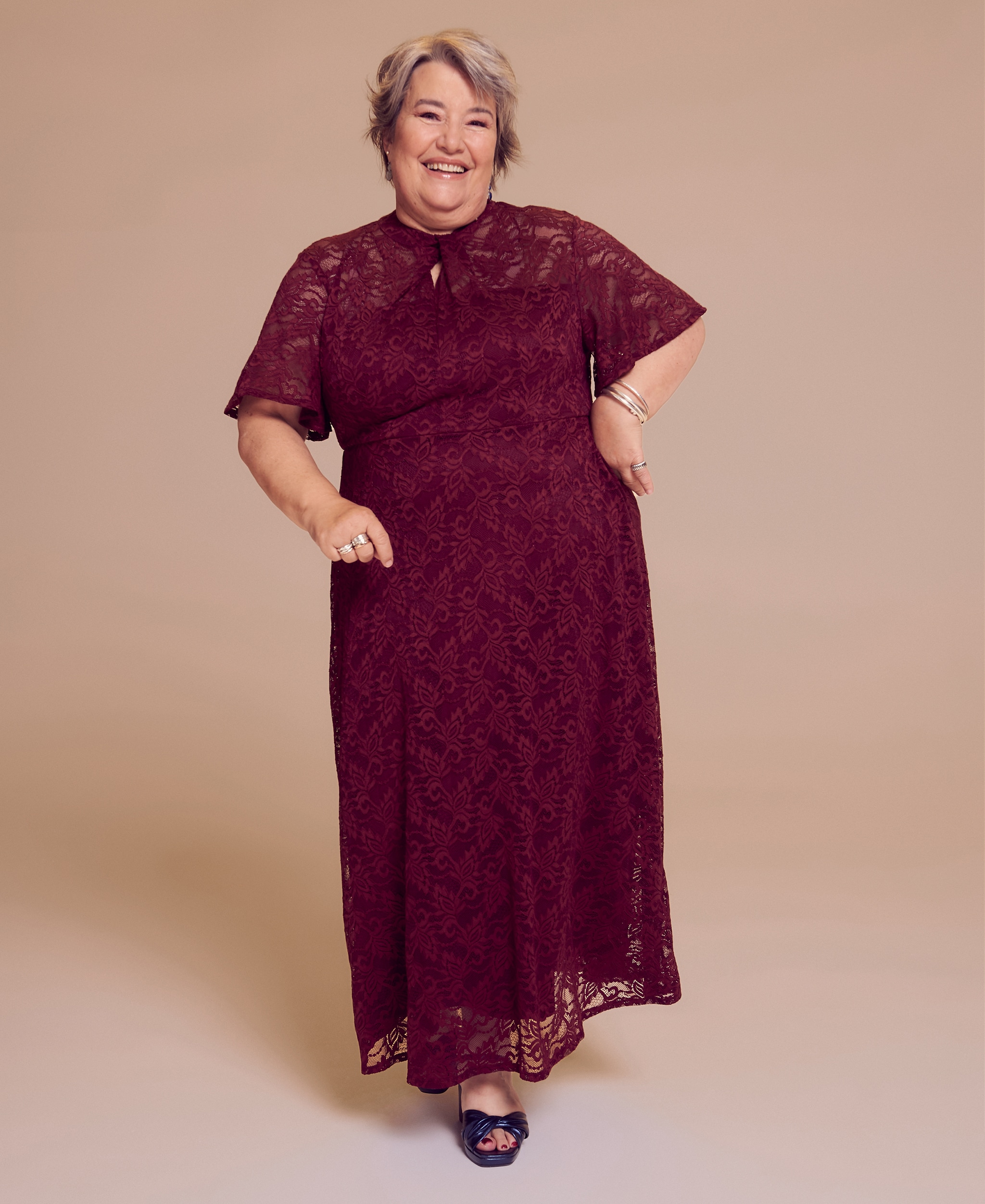 A women wearing a burgundy crochet knit dress