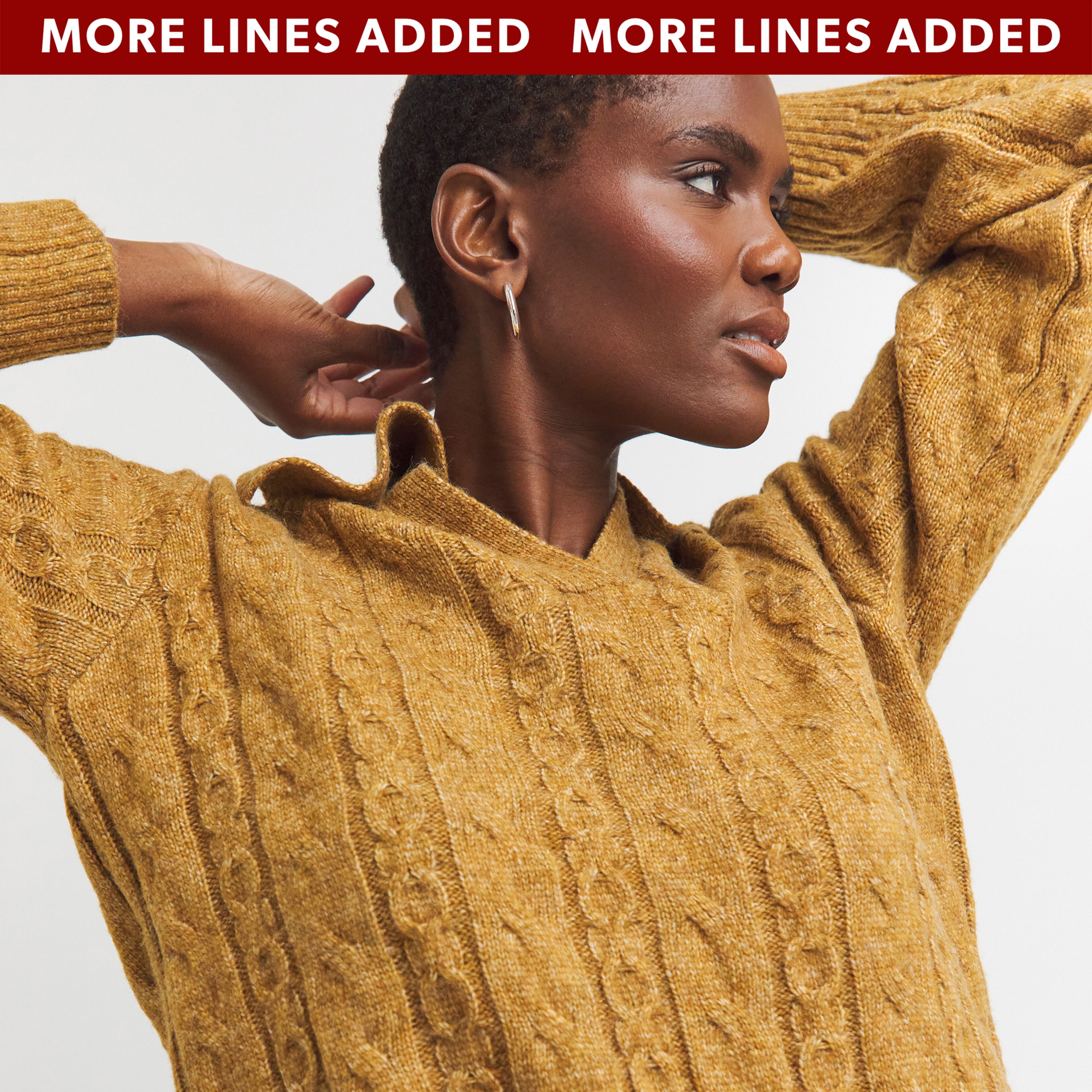 A model wearing a tan-coloured jumper.