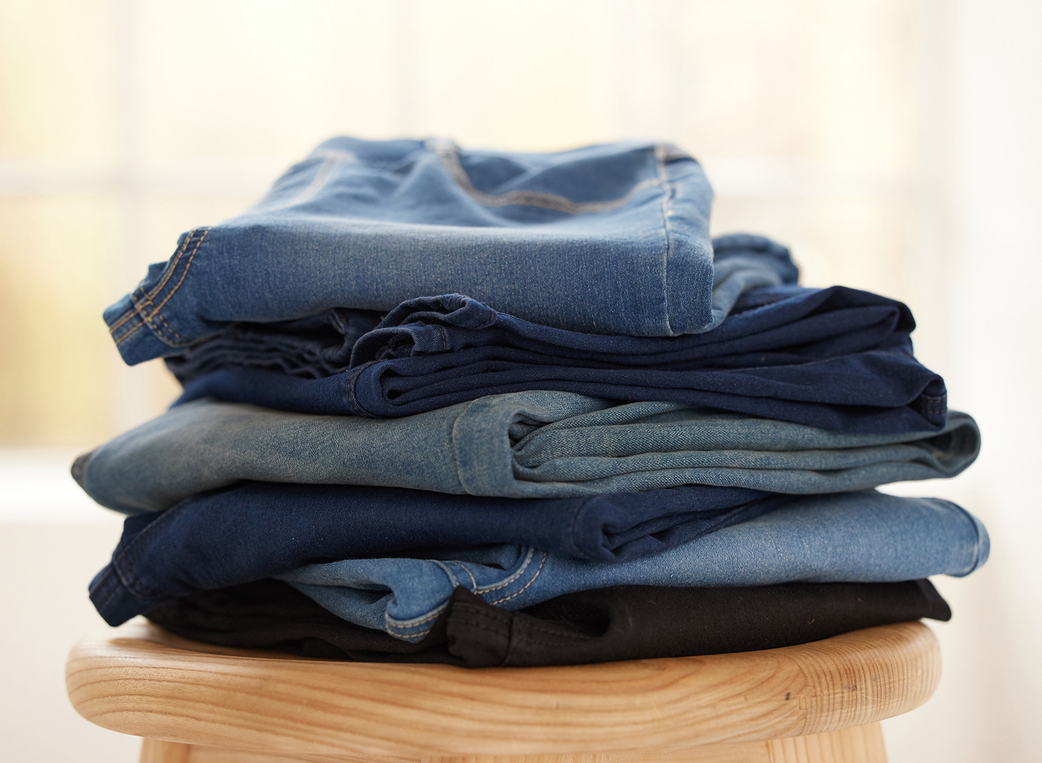 A pile of different coloured jeans