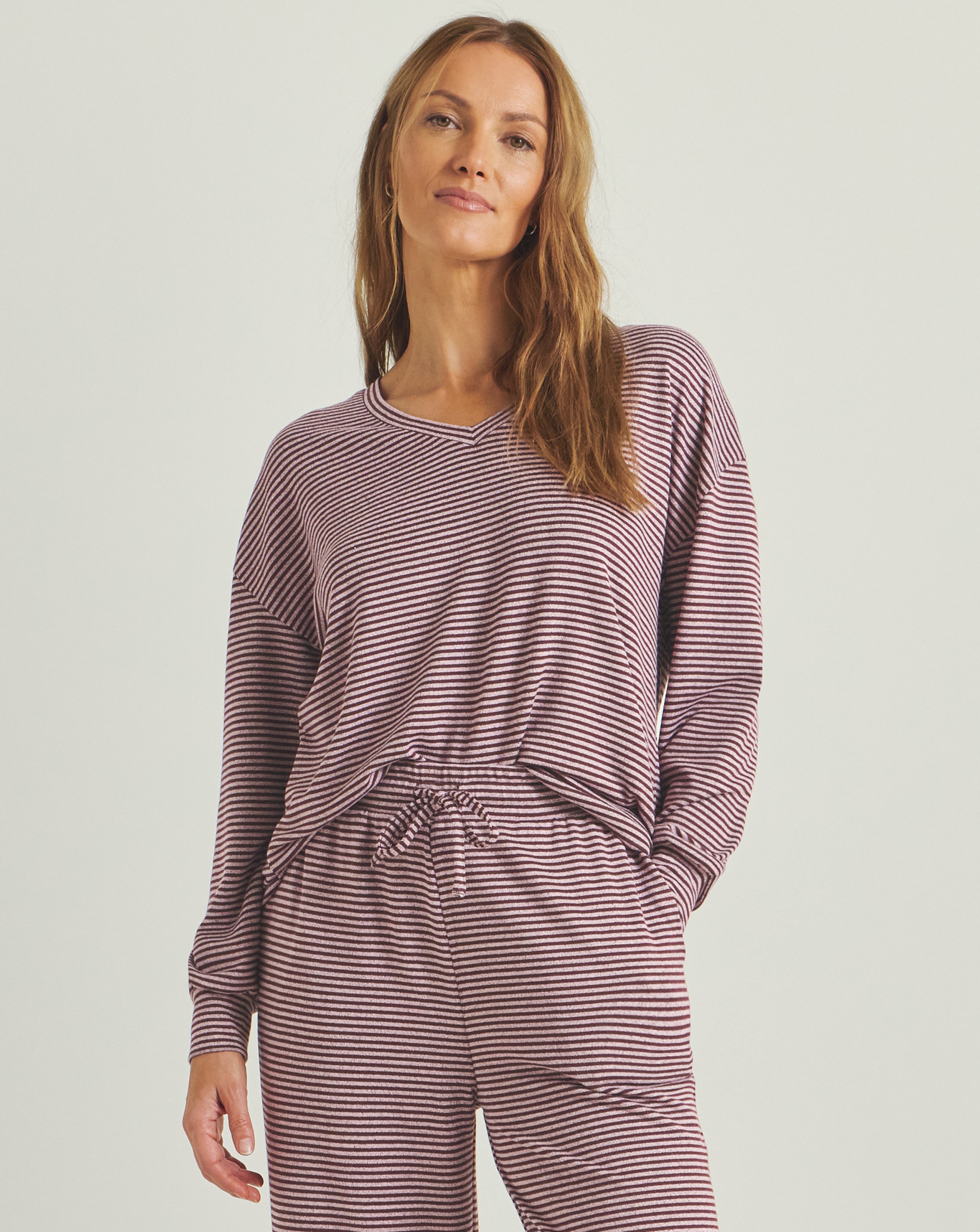 A model wearing a pink Pretty Secrets soft knit lounge set