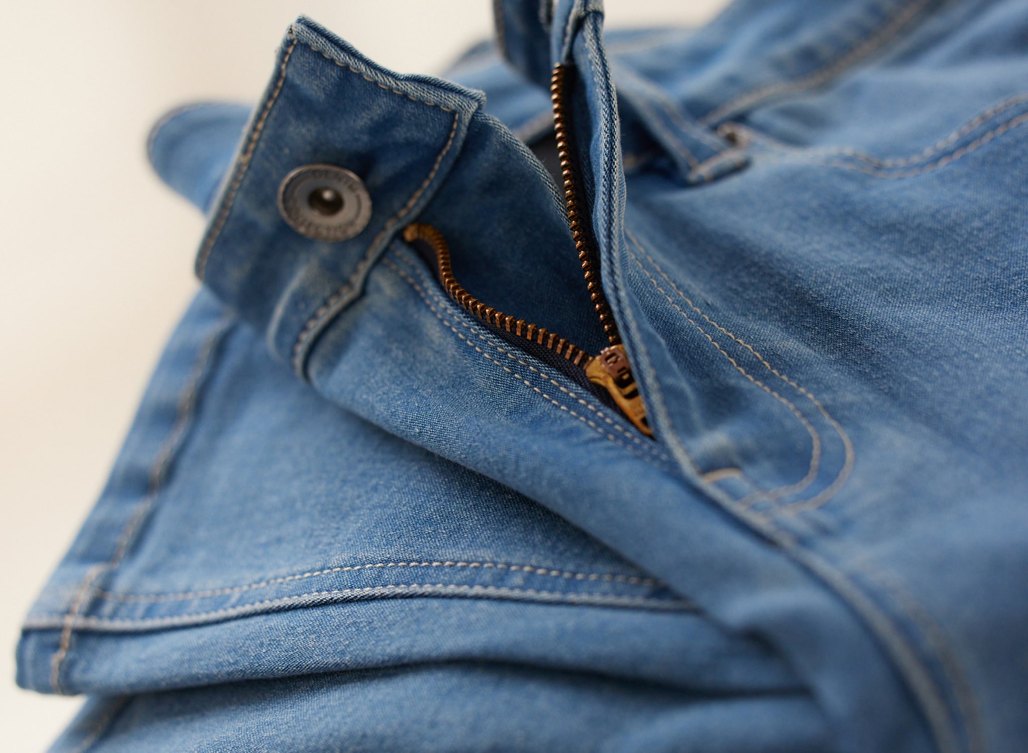 A pair of jeans showing the zip and fly detail