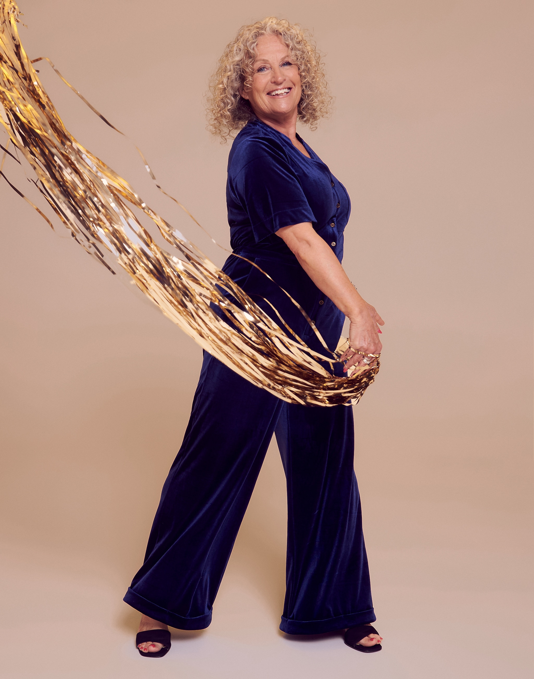 A women wearing a Christmas sparkly trouser suit