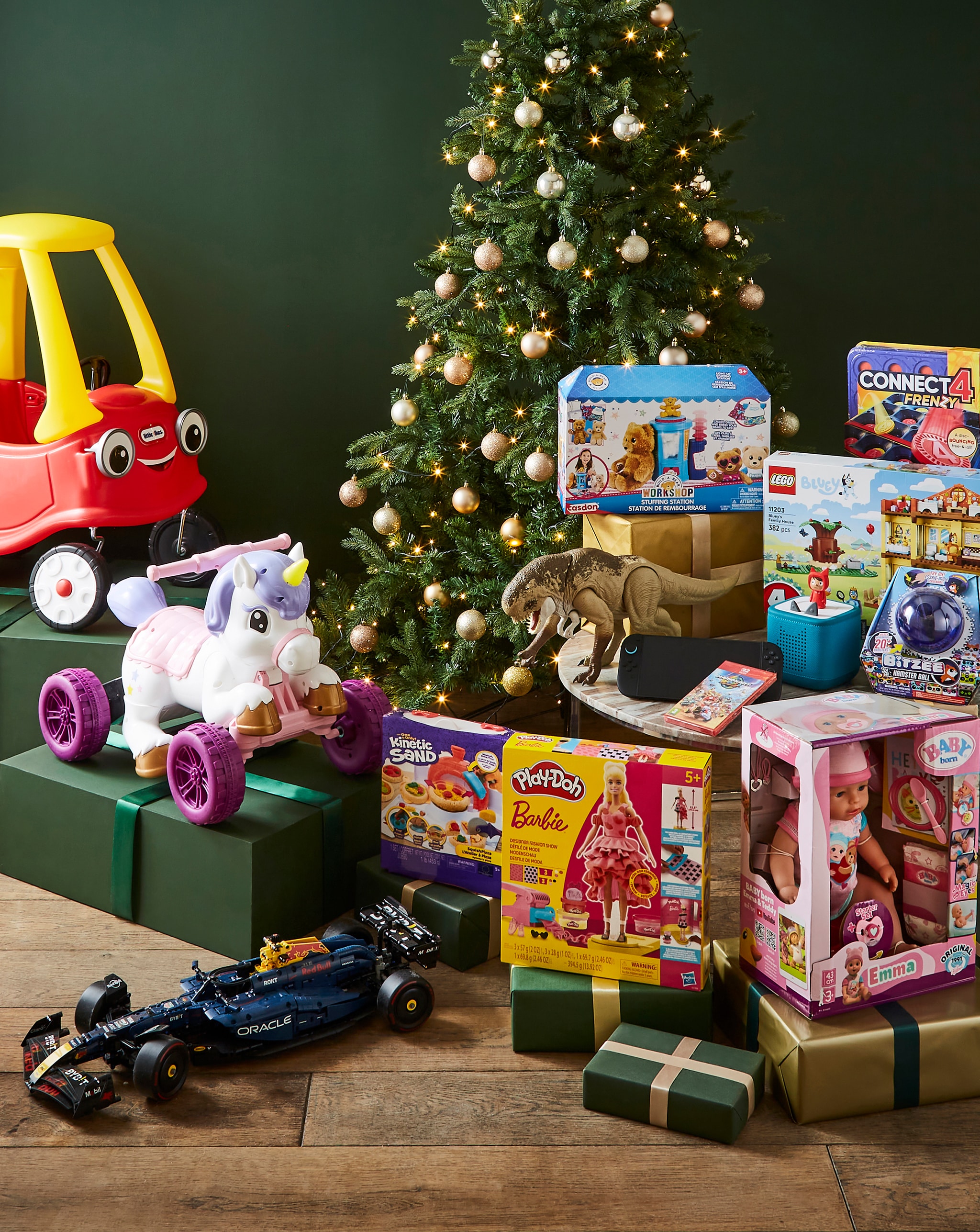 Christmas tree surrounded by children's toys and wrapped gifts.