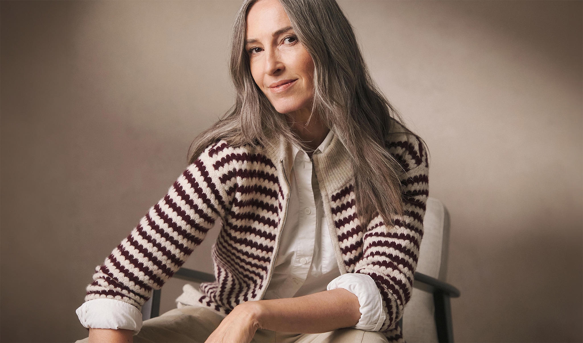 Woman wearing a brown hooped cardigan
