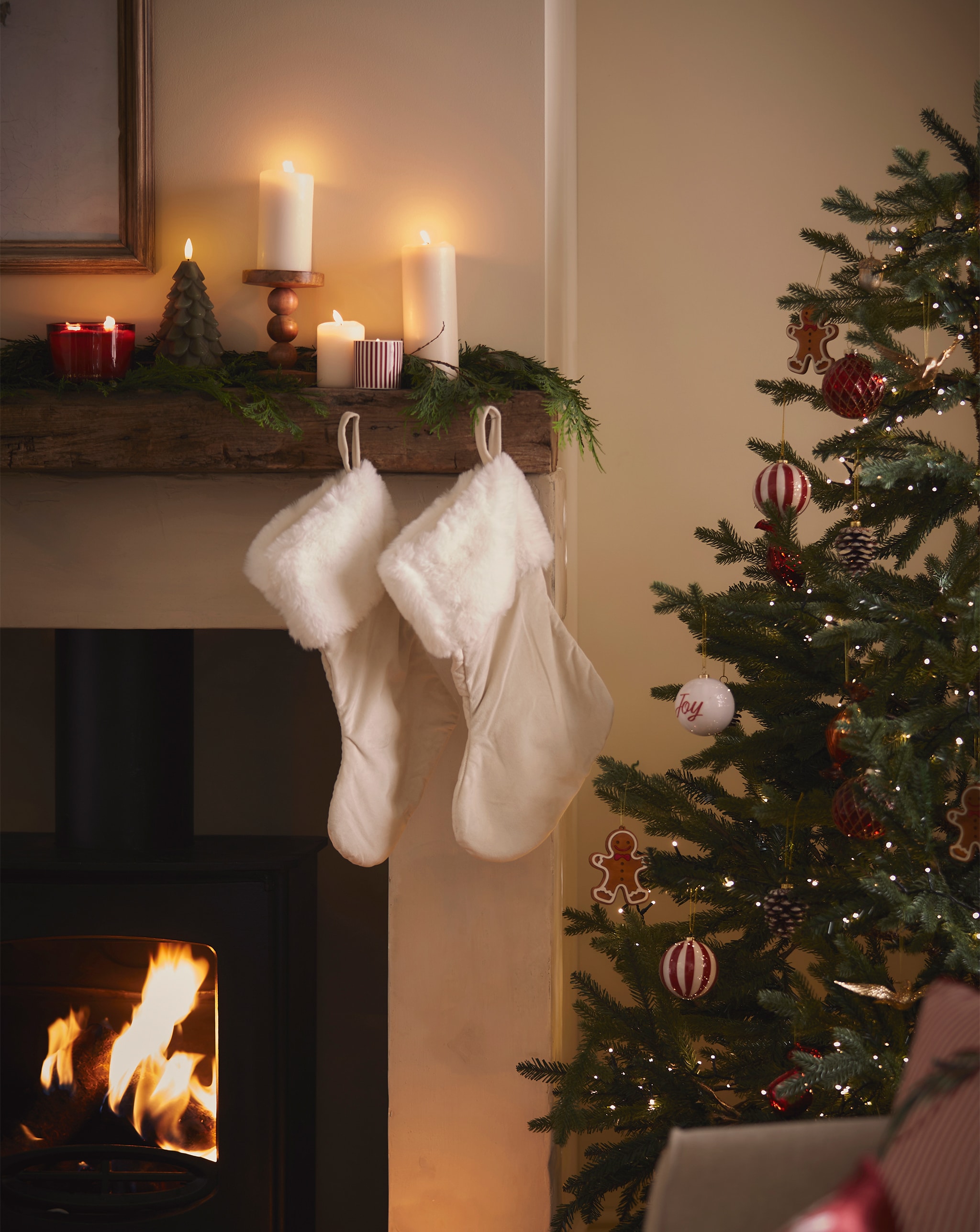 Stockings hanging from the mantlepiece in a festive living room.