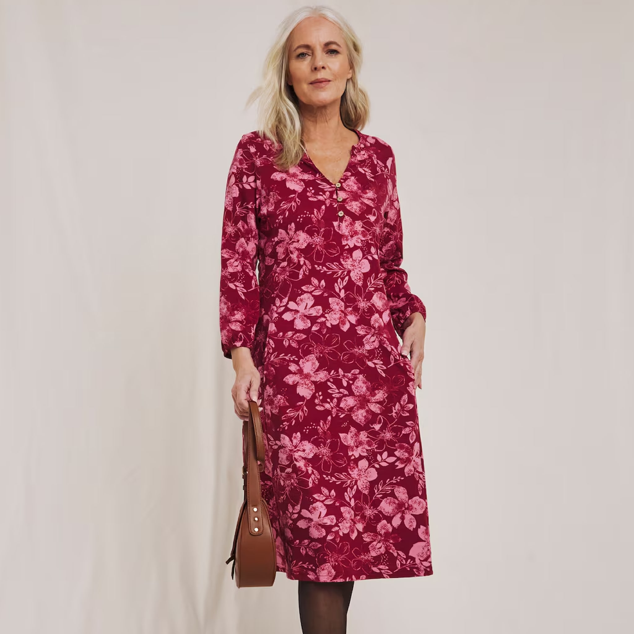 A woman stood wearing a pink value dress