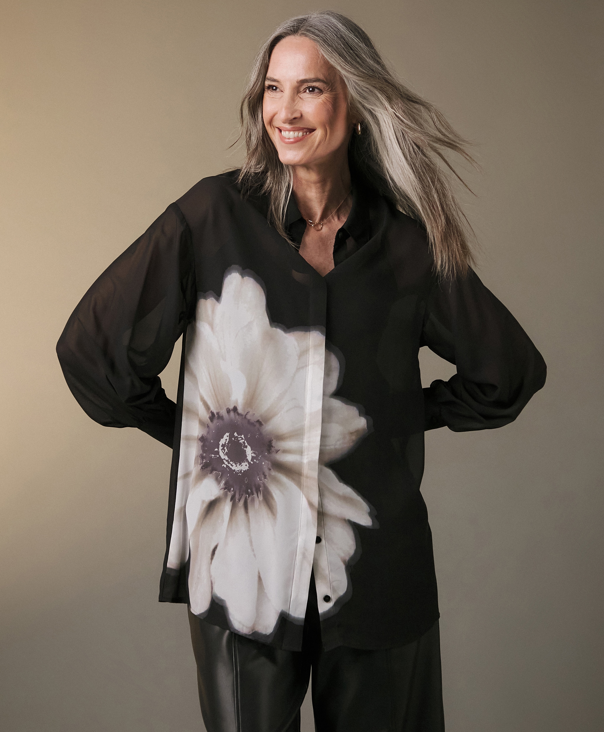 A woman wearing a black loose fitting top