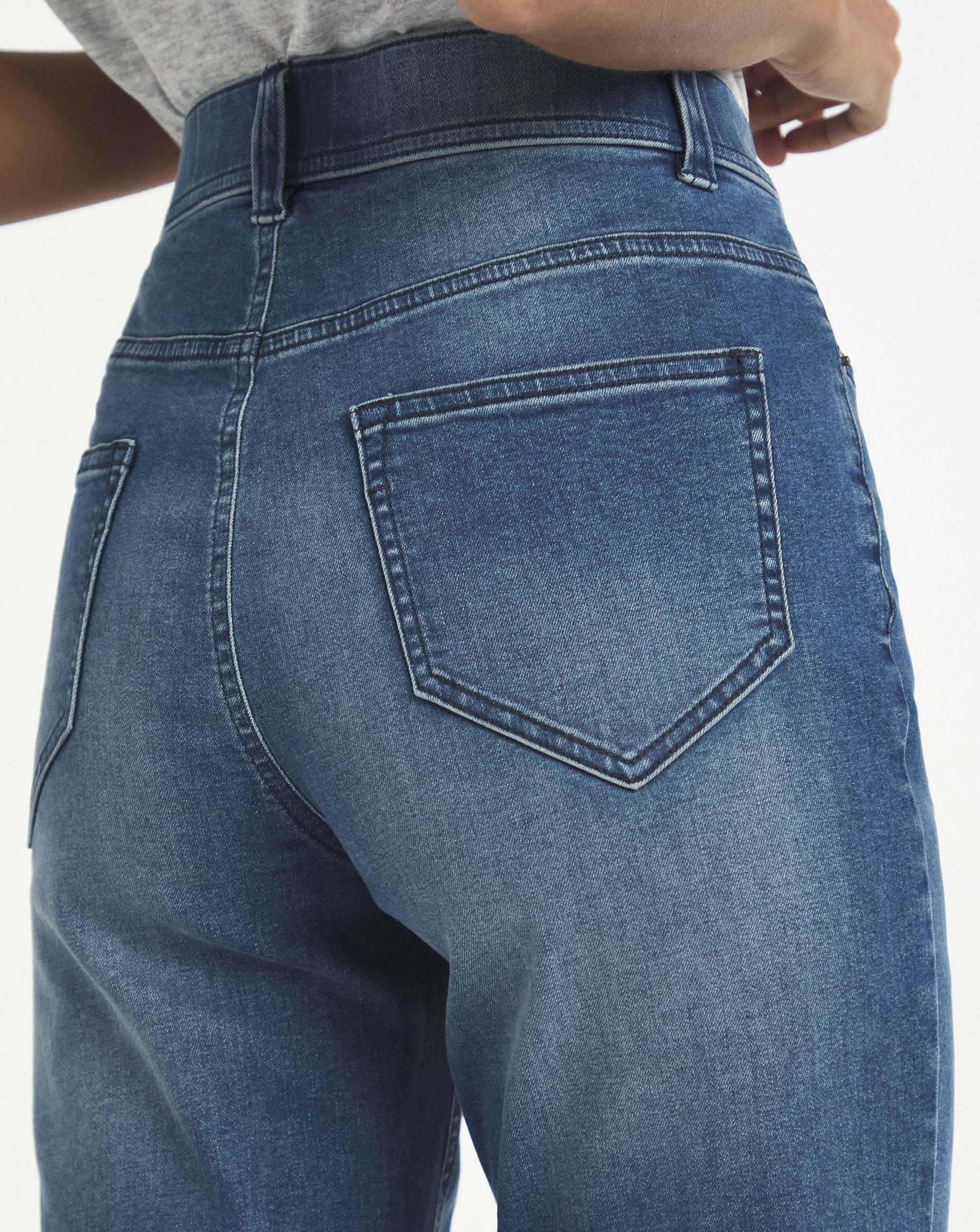 Model stood showing rear details of denim jeans
