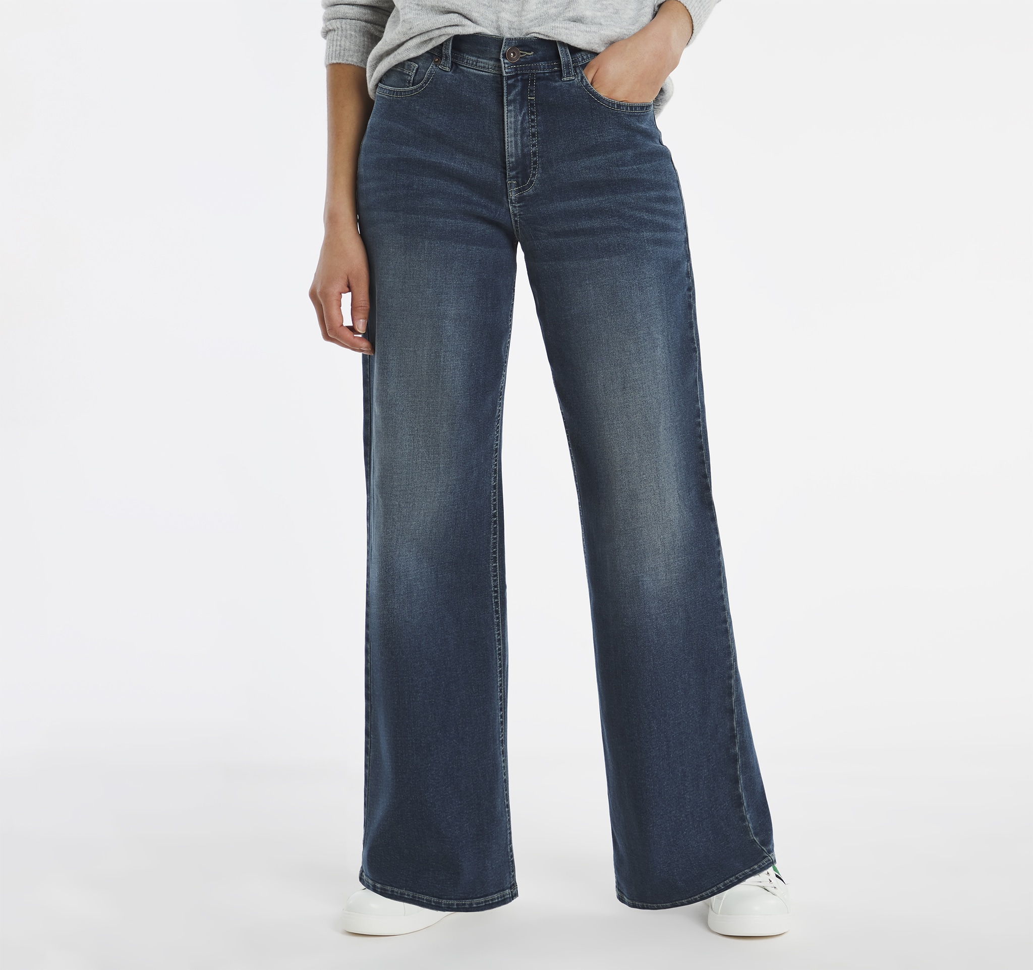 Model wearing wide fit jeans in dark blue