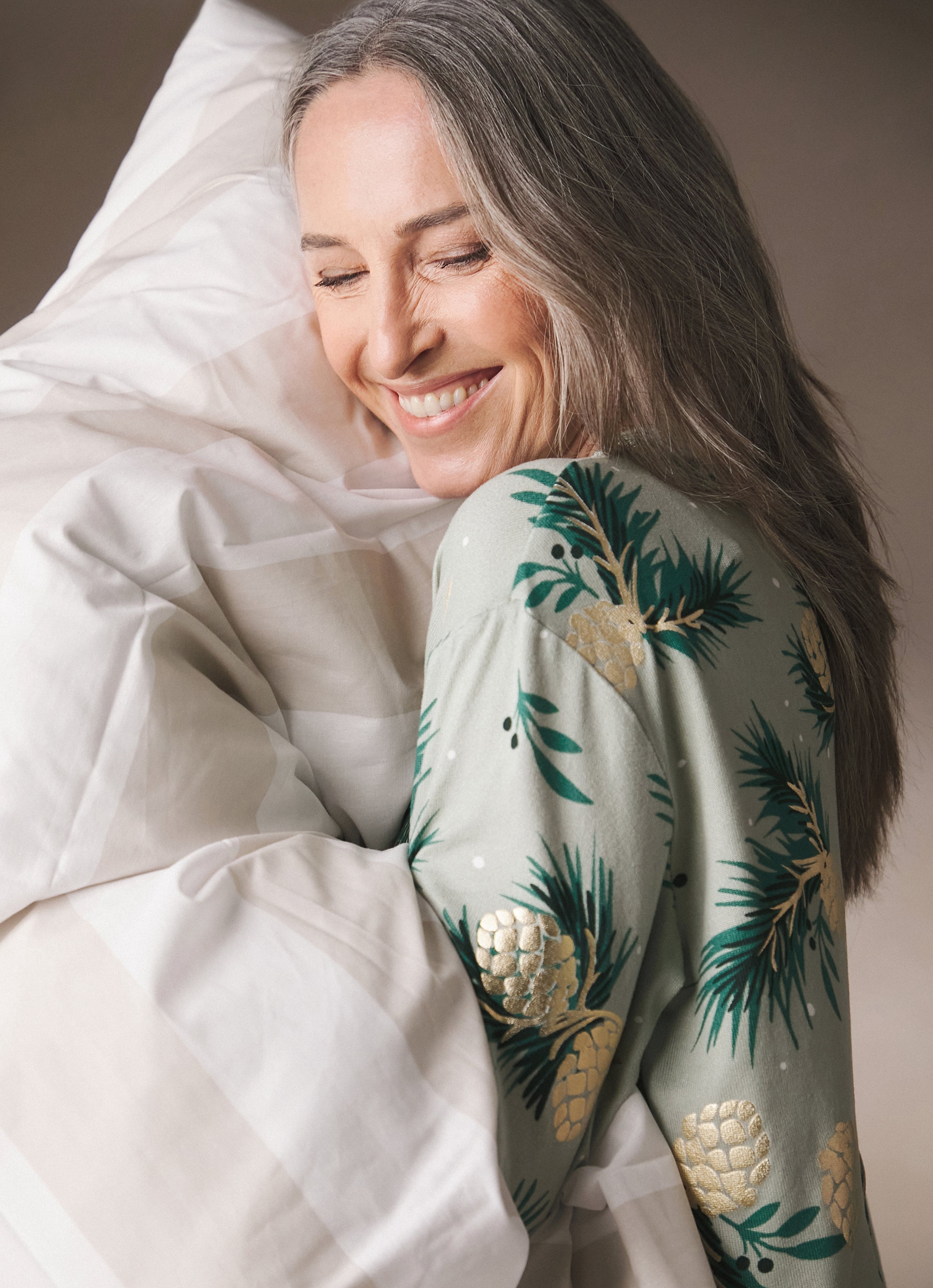 A woman wearing a green patterned blouse
