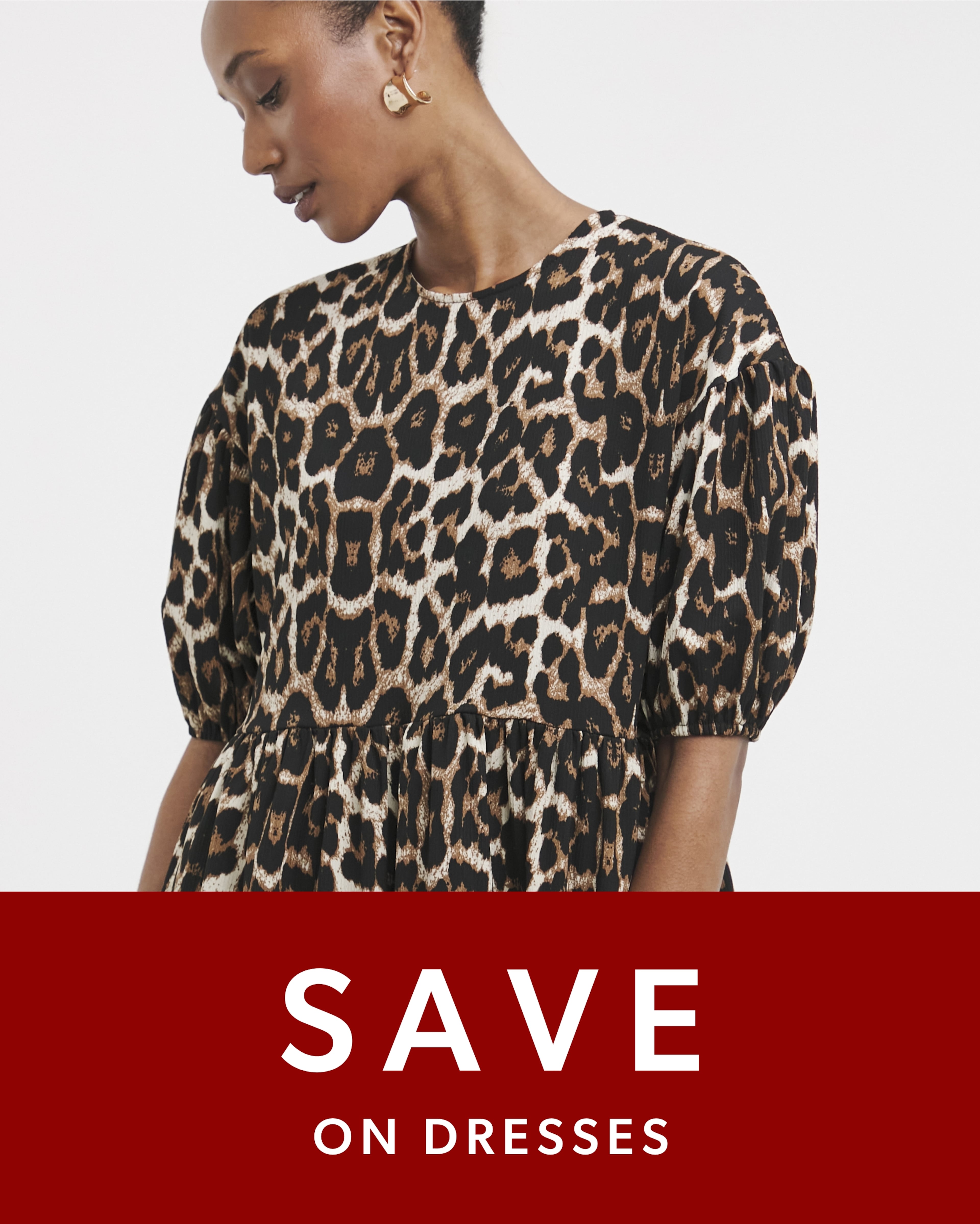 Person wearing a leopard-print dress with puffed sleeves.