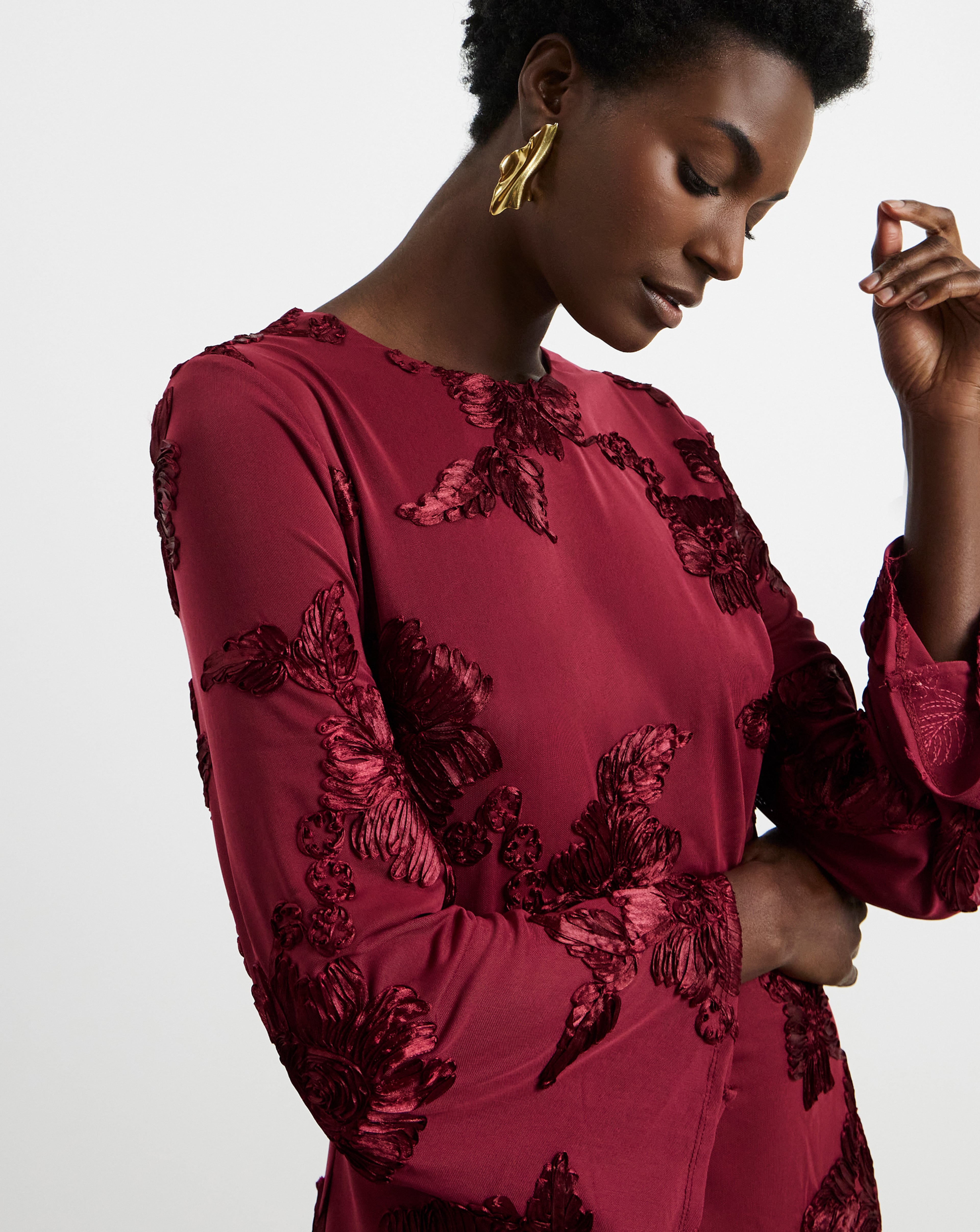 Model wearing a  plum-coloured Joanna Hope floral dress