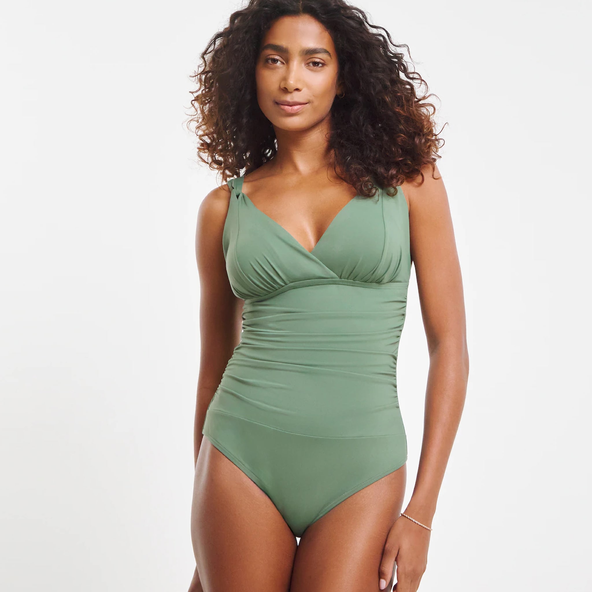 A model wearing a green swimsuit