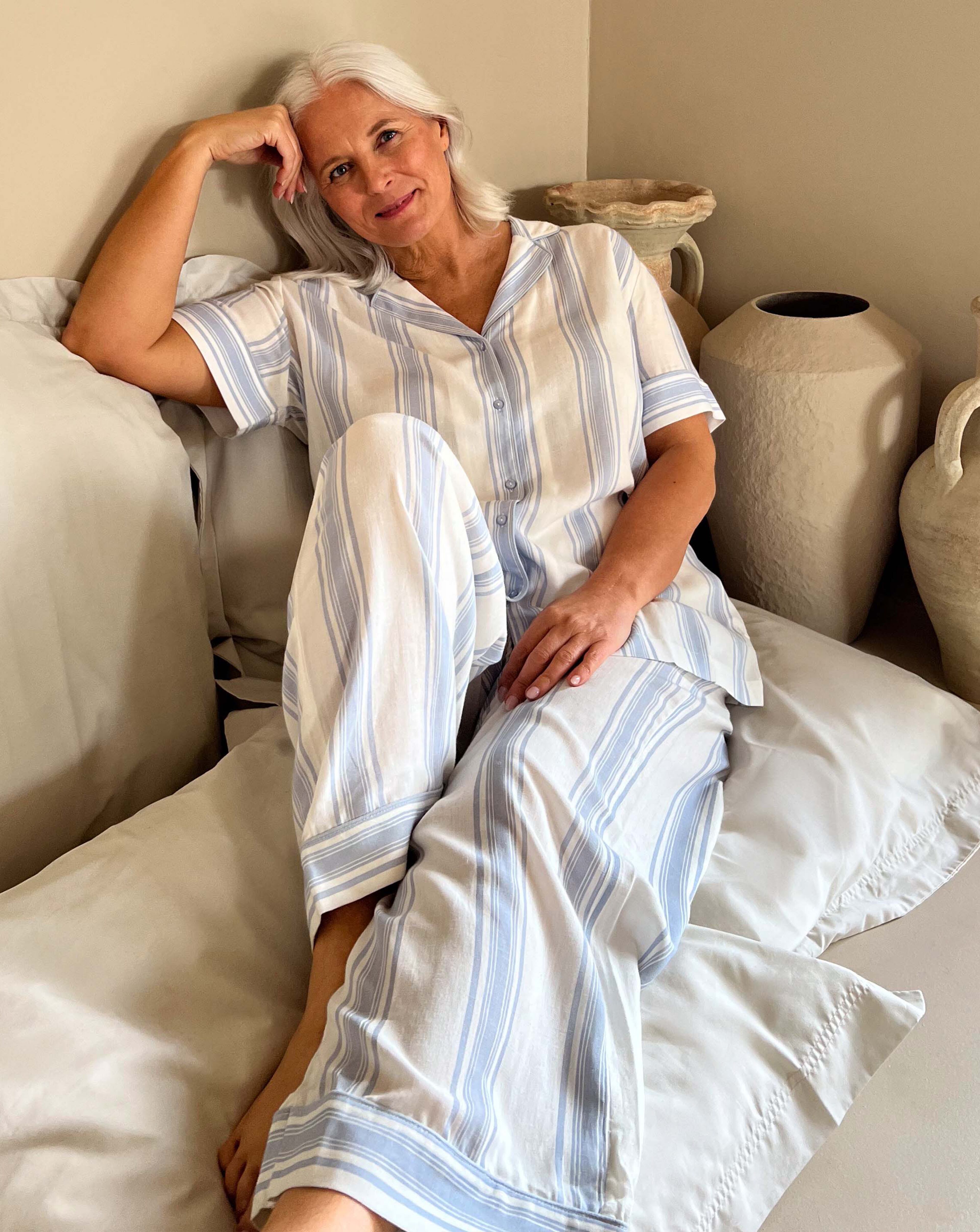 Woman on sofa in pyjamas