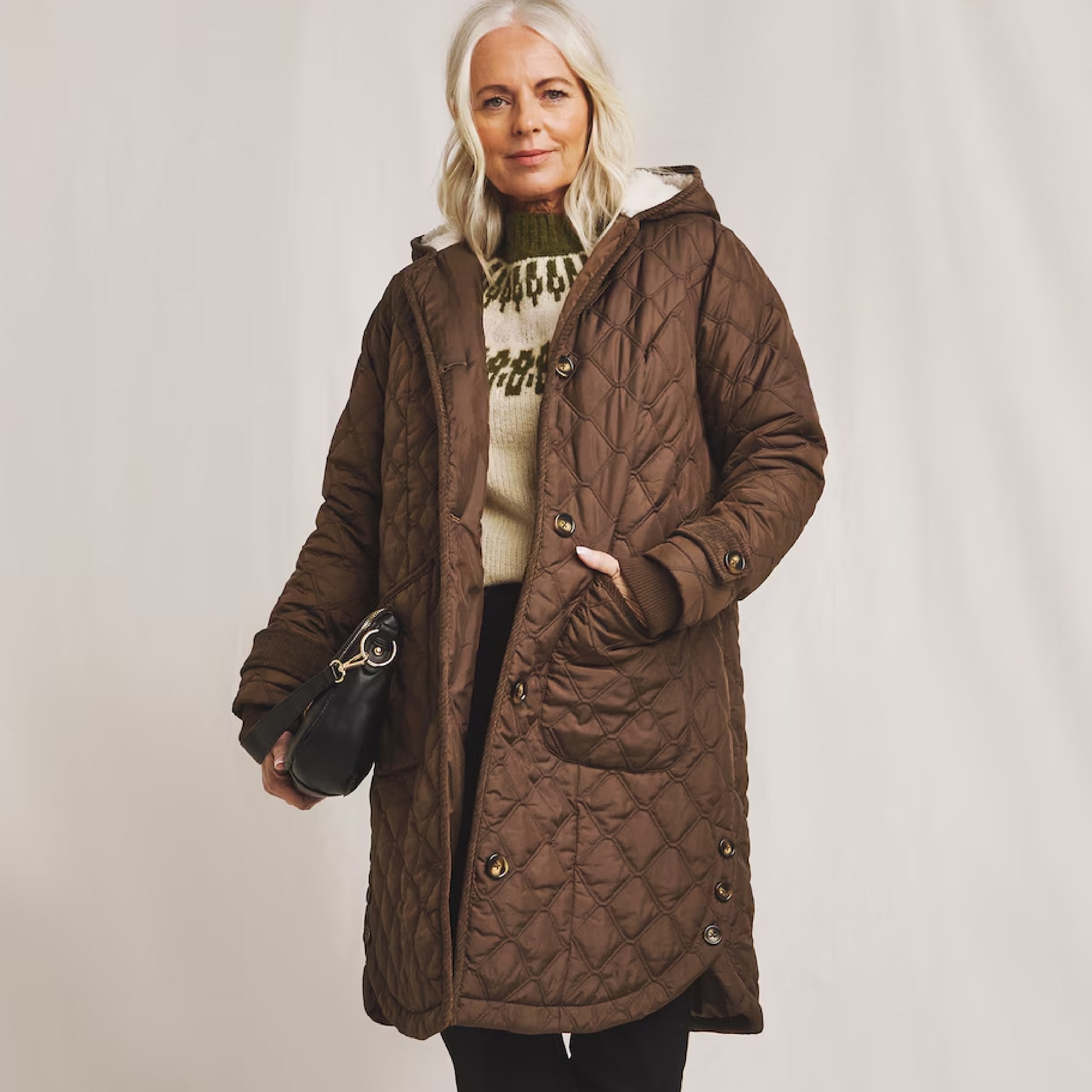 Woman stood wearing an olive coloured quilted coat