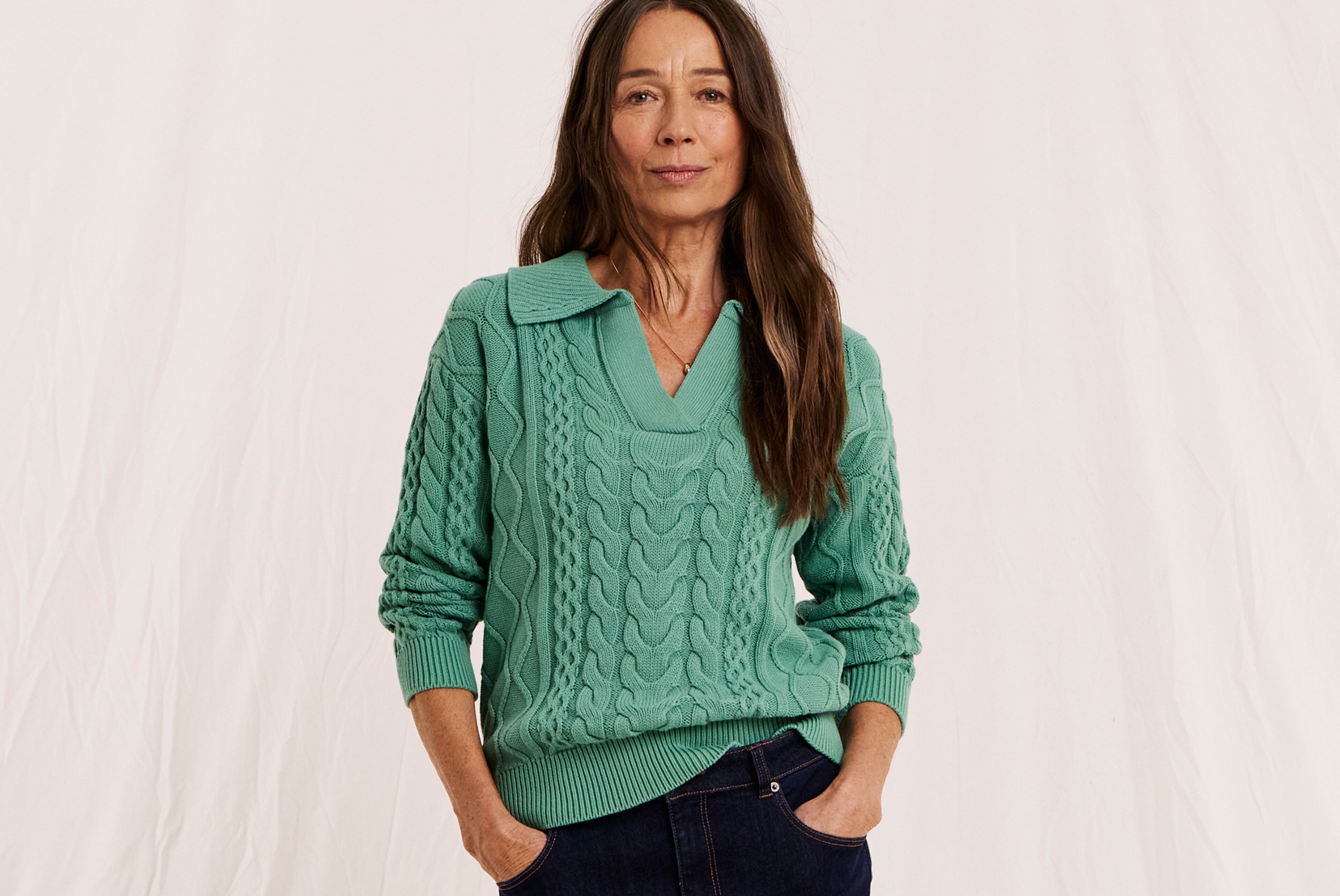 Model wearing a green Julipa jumper and black jeans.