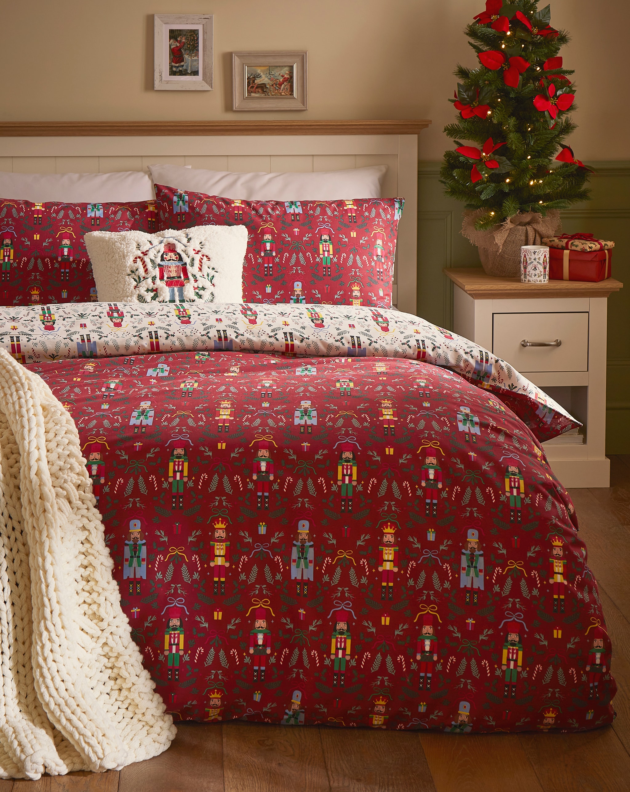 A festive red patterned bedding set on a double bed.