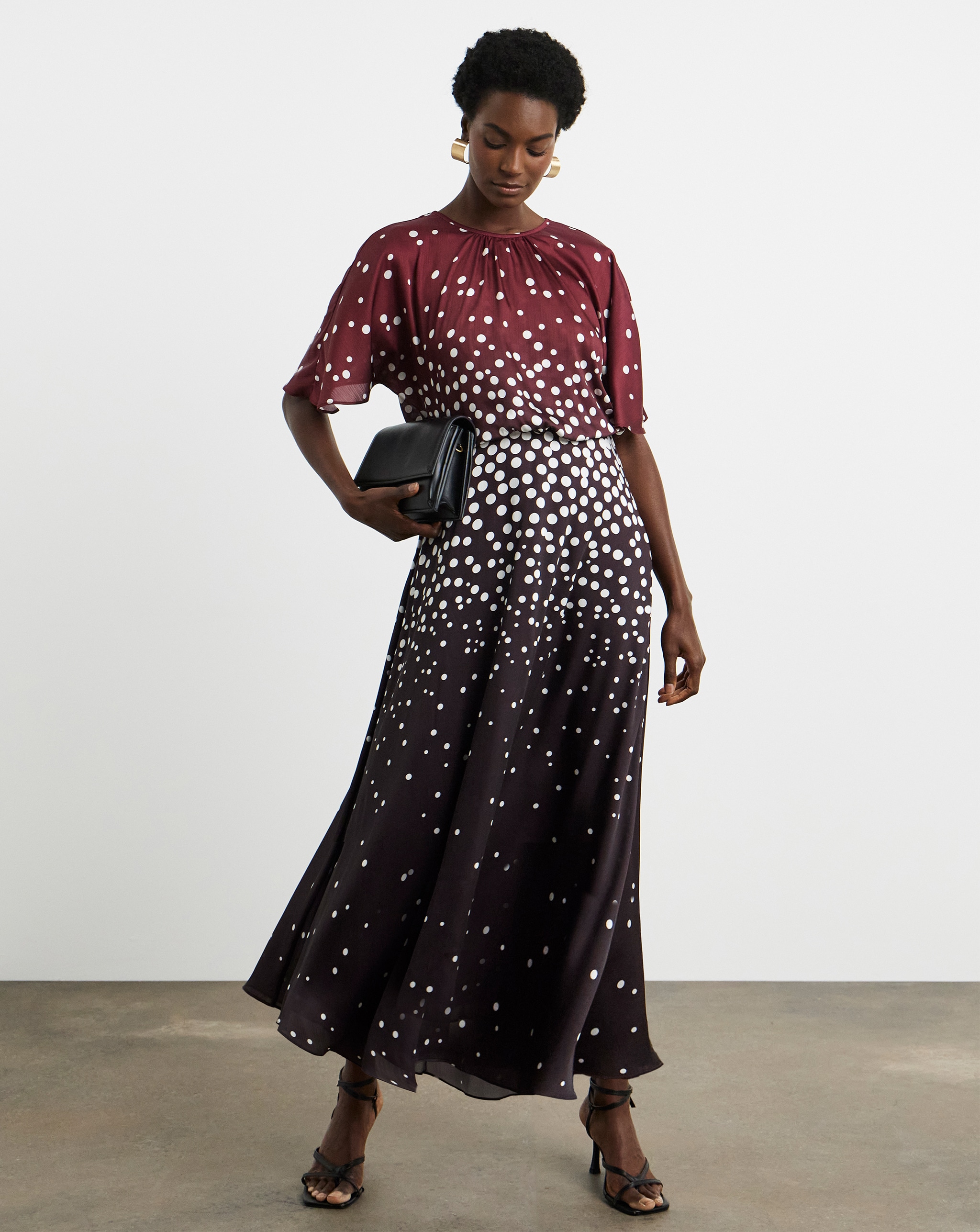Person wearing a Joanna Hope burgundy print maxi dress.