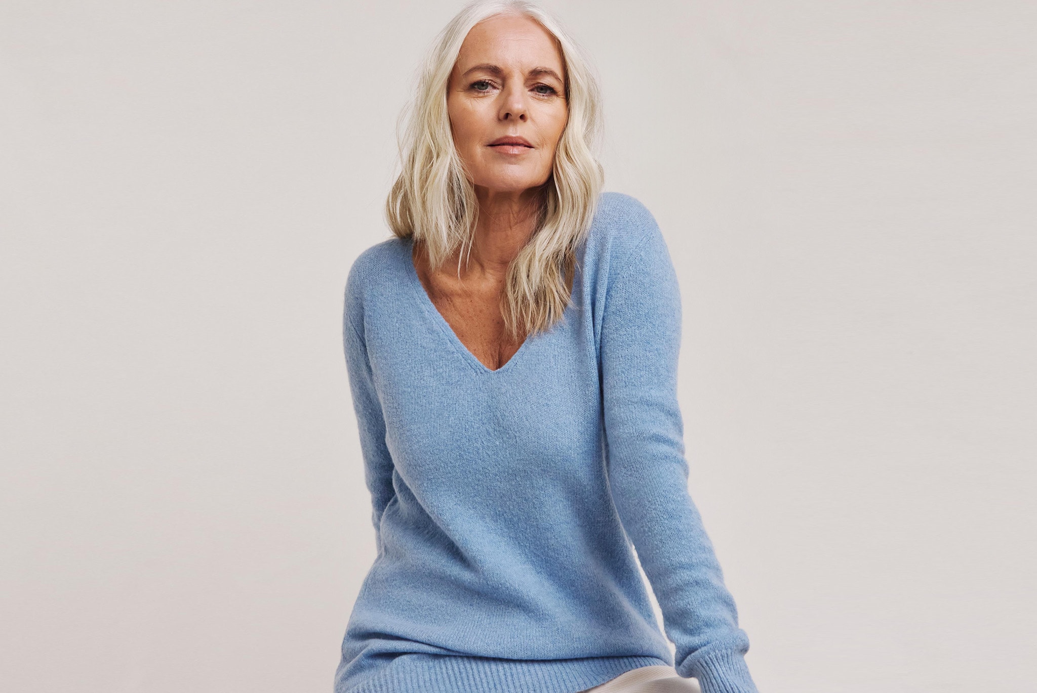 Model wearing a blue wool jumper
