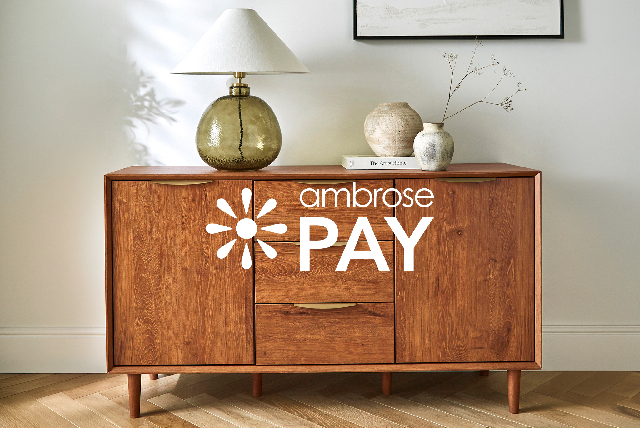 Westcote walnut sideboard in a hallway, with a decorative lamp, books and plant pots on top