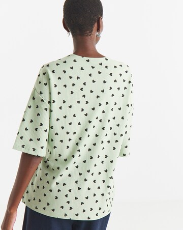 Sage Heart Print Textured V-Neck Zip Front Short Sleeve Longline Top